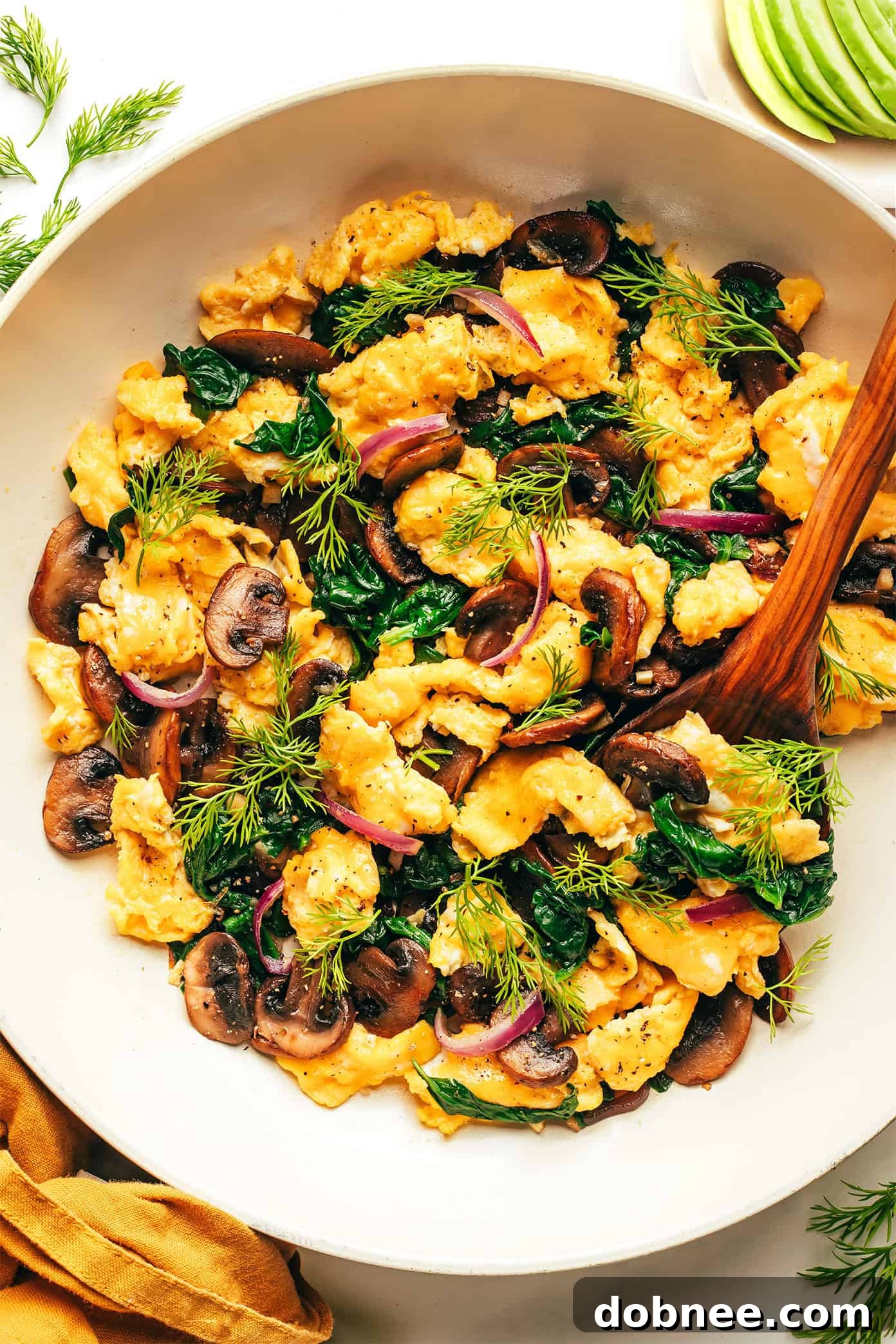 A final shot of the spinach mushroom egg scramble, beautifully presented in a bowl, inviting you to take a bite.