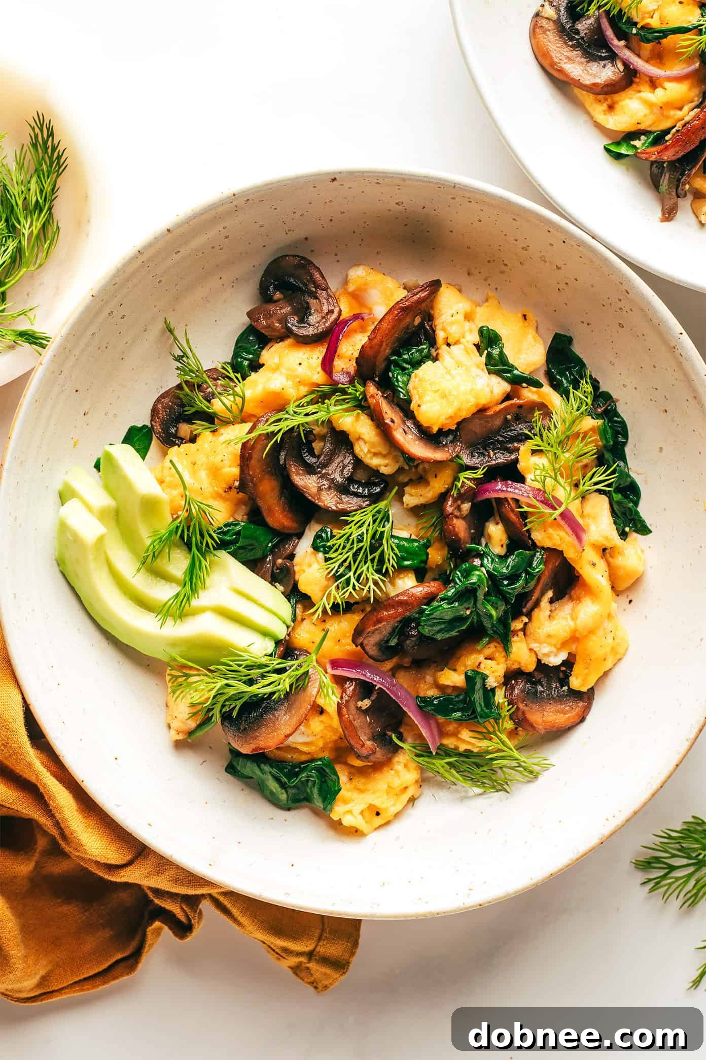 A top-down view of the spinach mushroom egg scramble, showing the rich colors and textures of the ingredients.