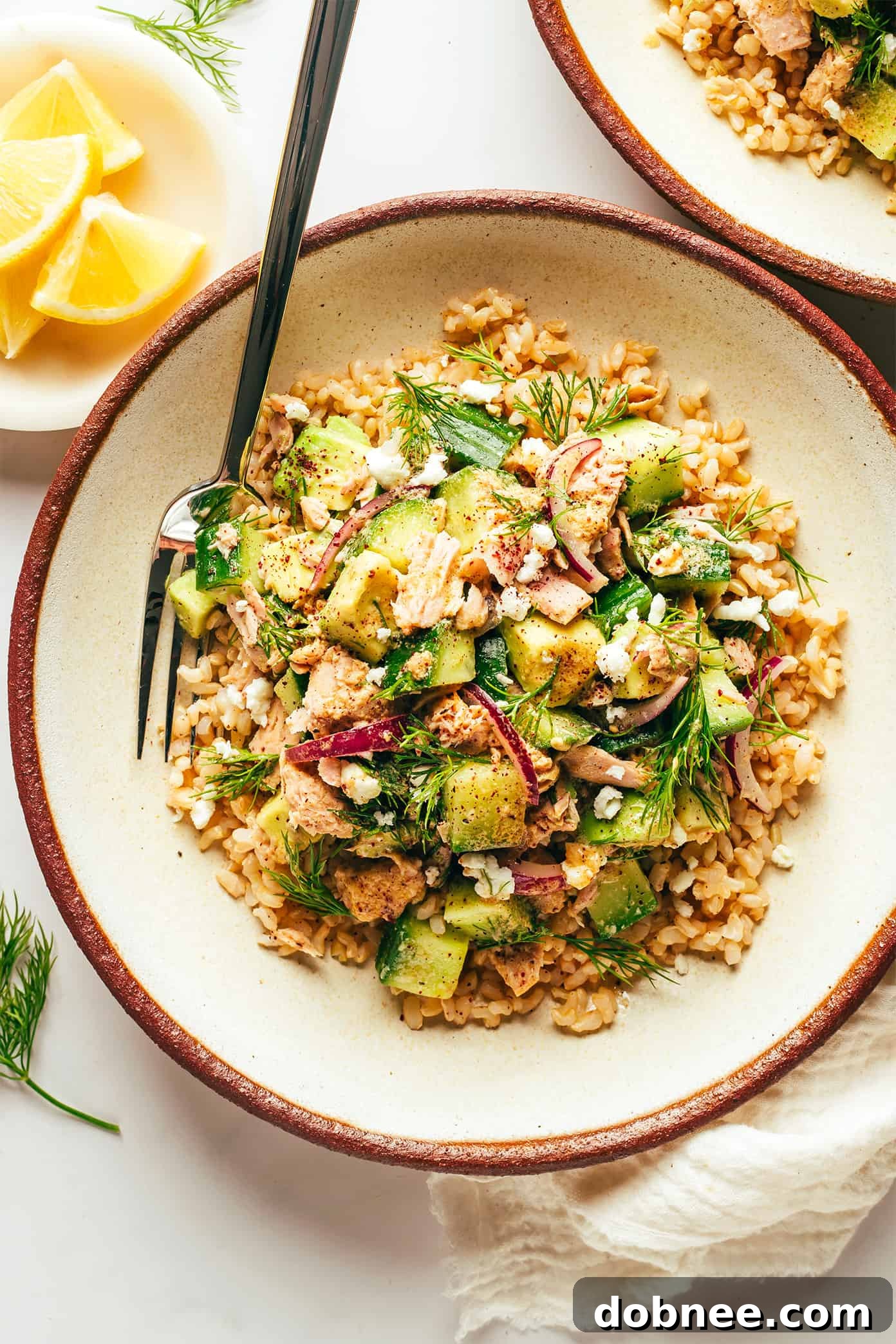 Completed Tuna Avocado Brown Rice Bowls with lemon wedges