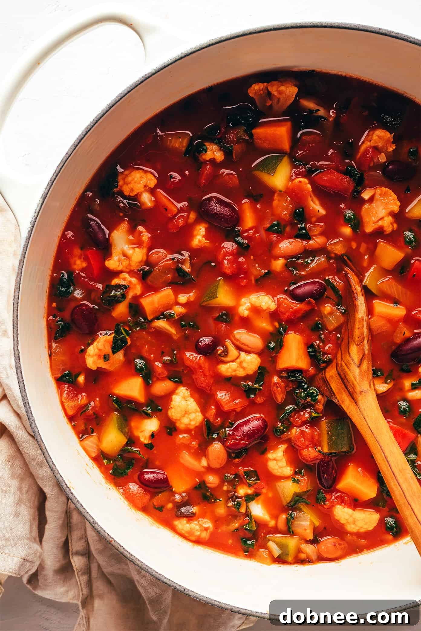 Extra-Veggie Vegetarian Chili simmering in a large pot, showcasing its rich texture and colorful vegetables, ready to be served.