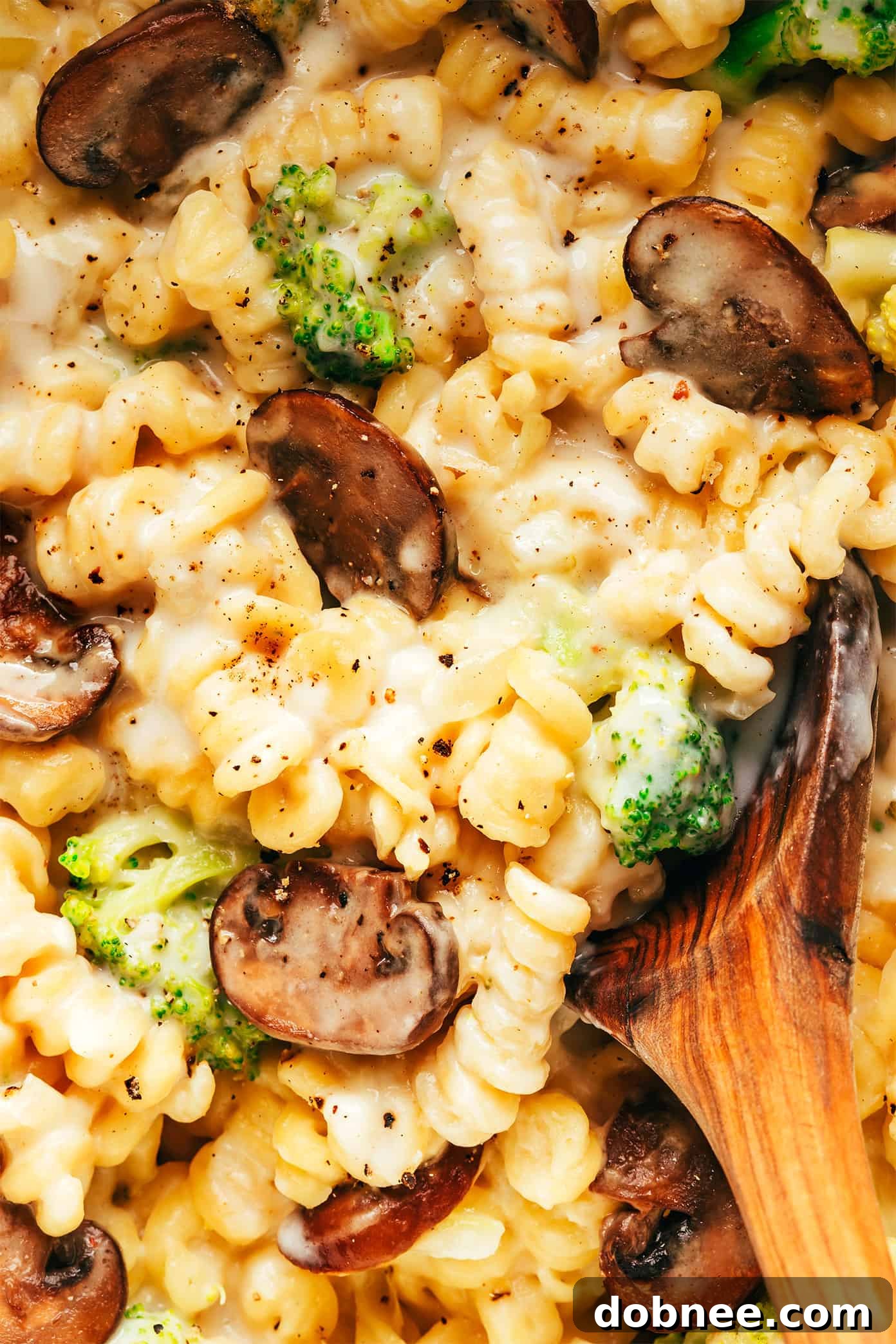 Closeup of creamy One Pot Broccoli Mac and Cheese with a spoon