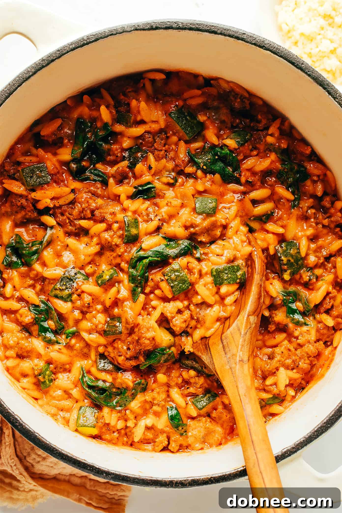 Delicious one-pot Italian Sausage Zucchini Orzo pasta dish with fresh basil