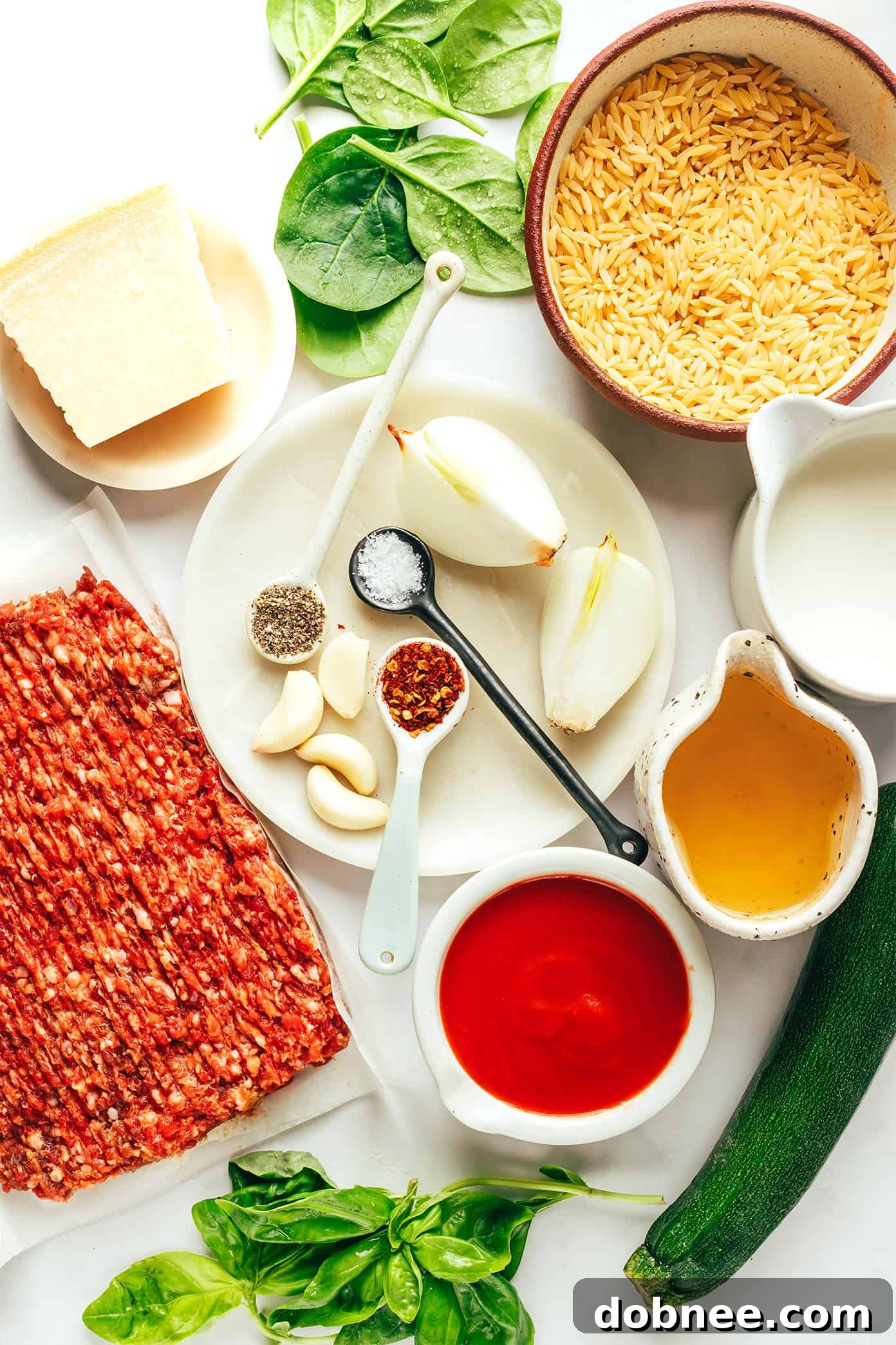 Close-up of creamy Italian Sausage Zucchini Orzo pasta with fresh basil