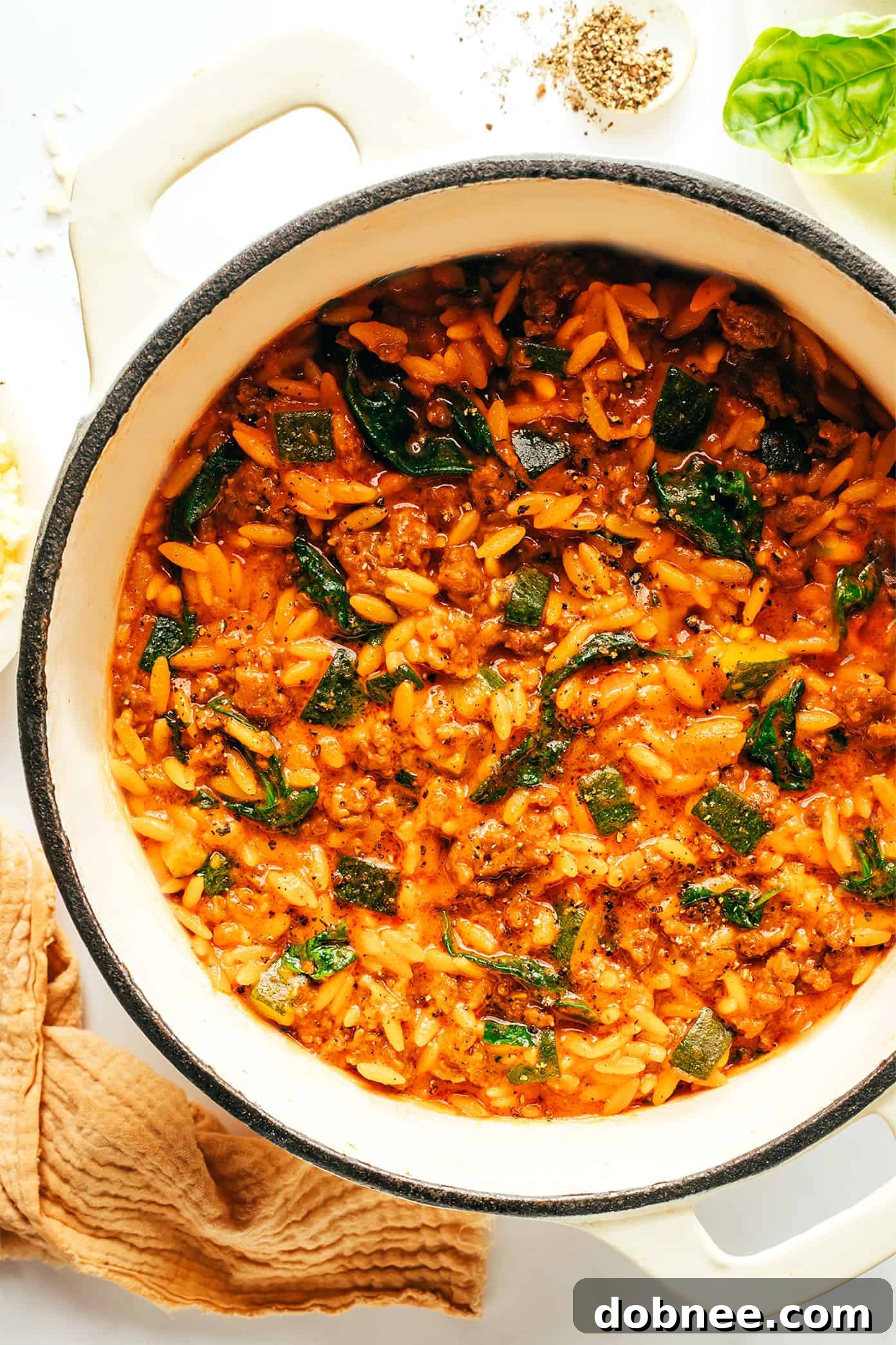 One-pot Italian Sausage Zucchini Orzo garnished with fresh herbs