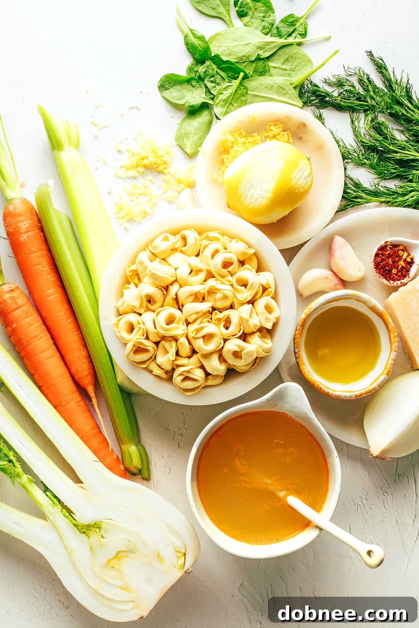 A close-up shot of tortellini simmering in a flavorful broth with vegetables.