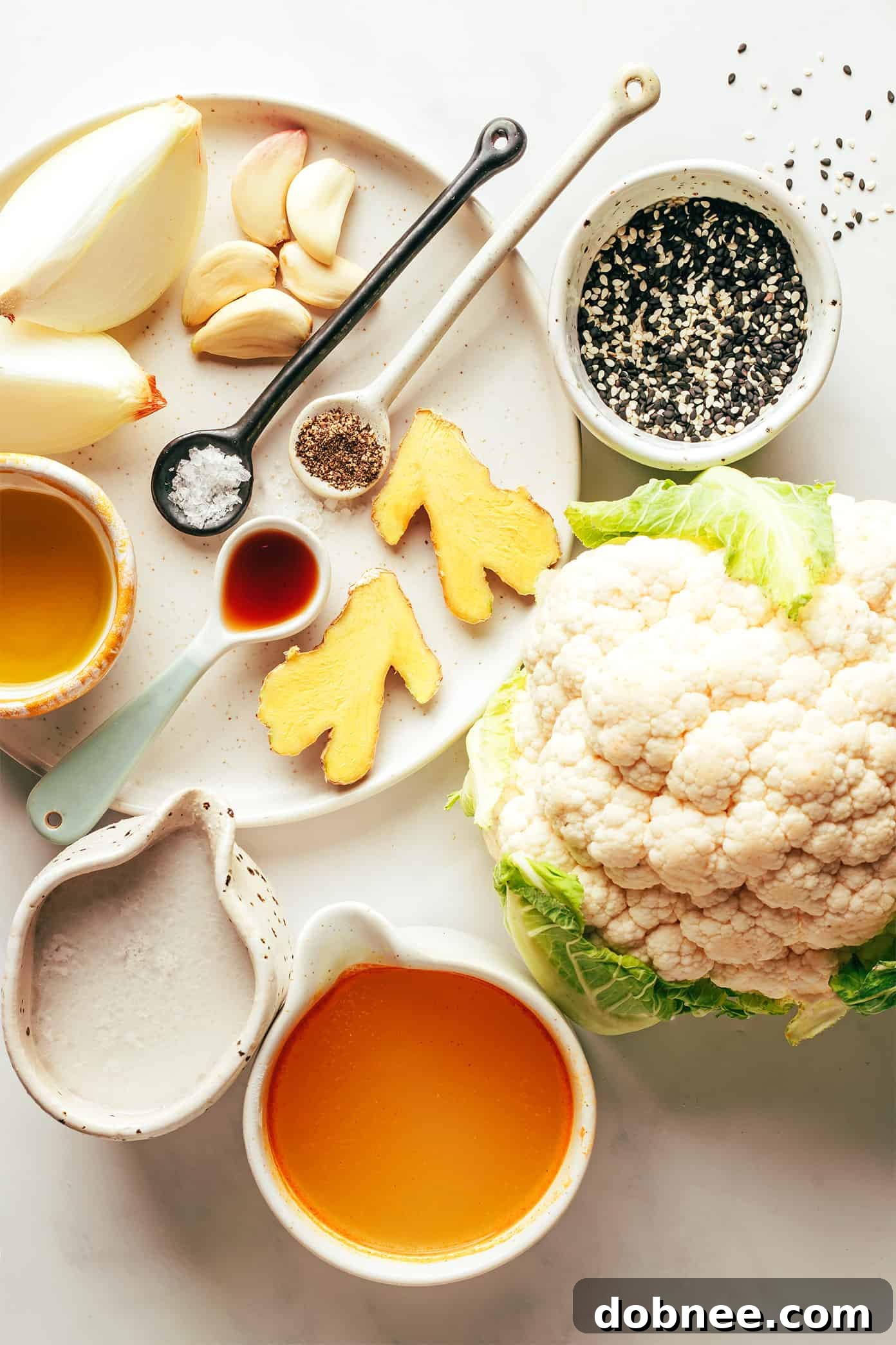 Close-up shot of roasted cauliflower florets on a baking sheet, golden brown and caramelized.
