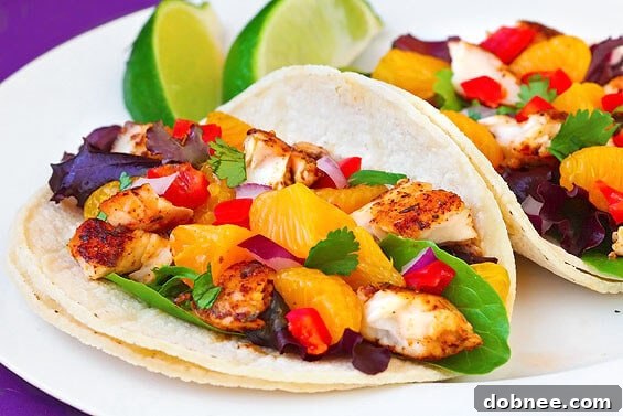 Freshly prepared healthy fish tacos with vibrant mandarin orange salsa and cilantro.