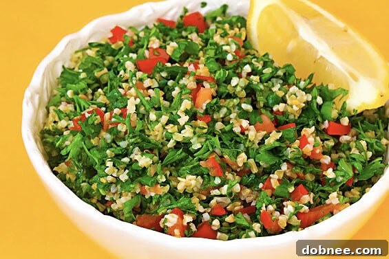 A vibrant bowl of fresh tabbouleh salad with finely chopped parsley, tomatoes, and bulgur.
