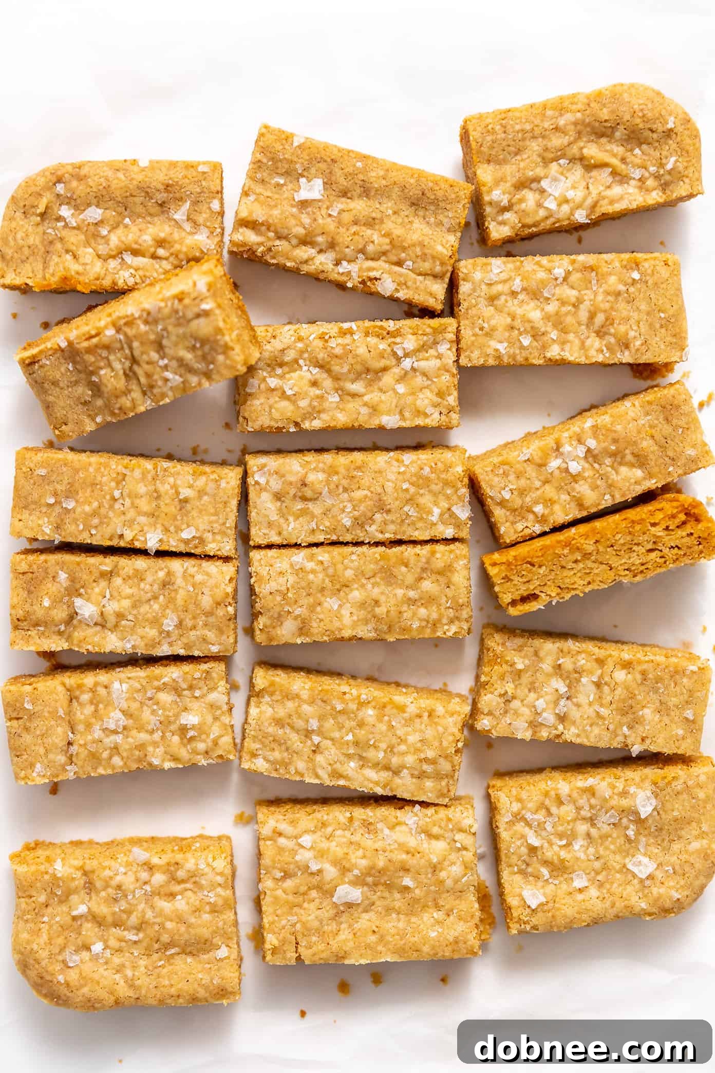 Various brown butter shortbread bars arranged artfully on a white surface