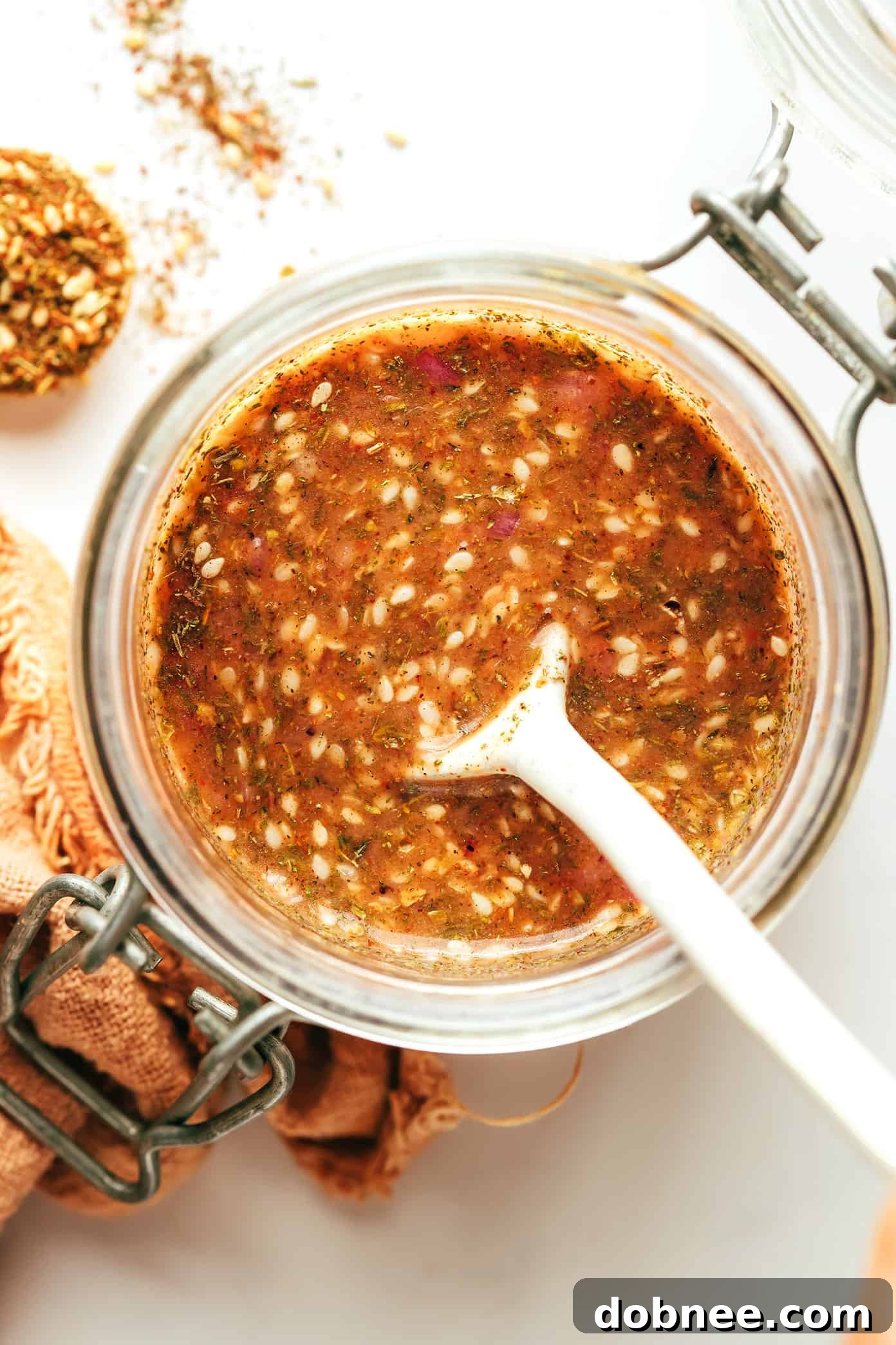 Lemony Za'atar Shallot Vinaigrette freshly prepared in a clear glass jar.