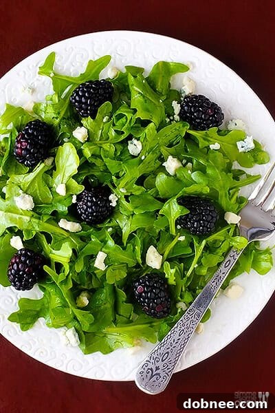 Easy Blackberry Arugula Salad - A close-up of a refreshing salad with fresh ingredients and a homemade dressing.