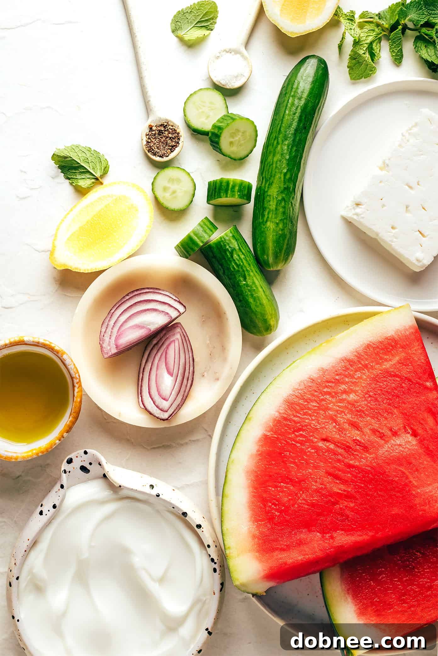 Close-up of a beautifully composed Watermelon Feta Salad with lemon and fresh mint garnishes