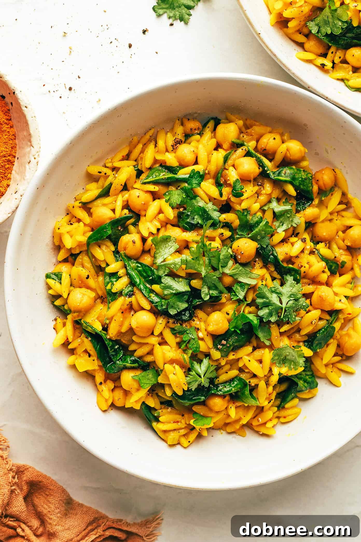 Lemony Spiced Orzo and Chickpeas in a pan with spinach