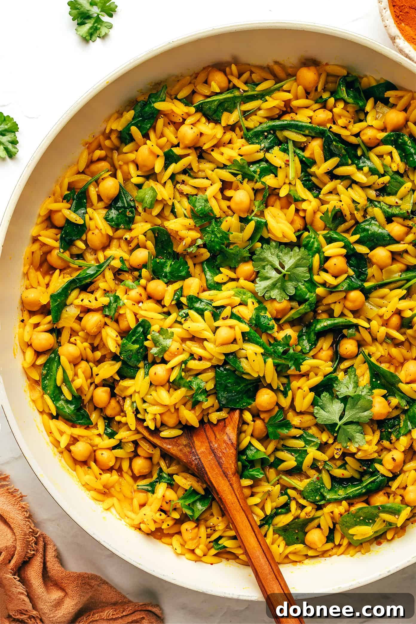 Lemony Spiced Orzo and Chickpeas in a pan with fresh cilantro