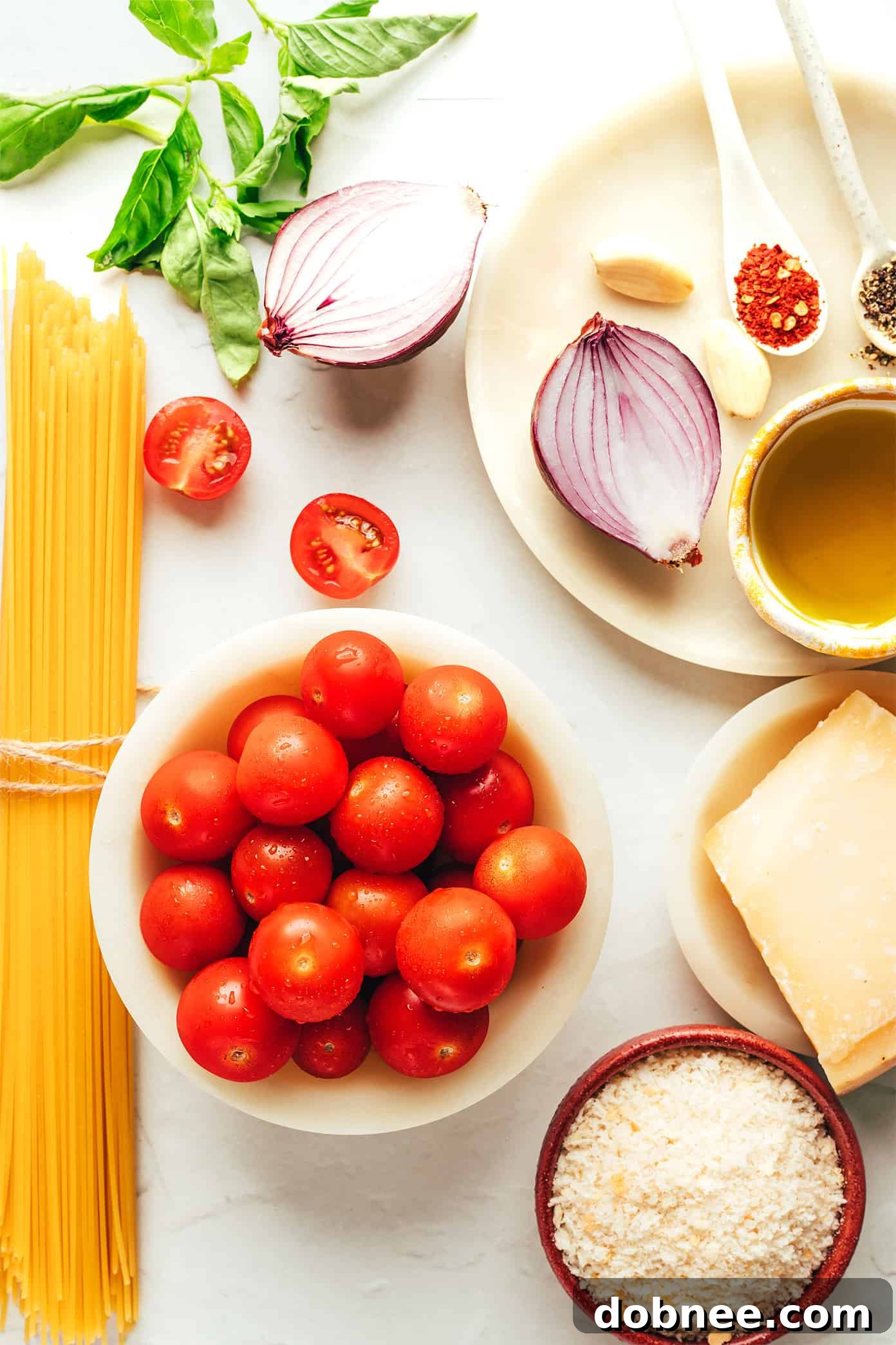 Close-up shot of Bruschetta Pasta garnished with fresh basil leaves and more crispy breadcrumbs, emphasizing its fresh ingredients.
