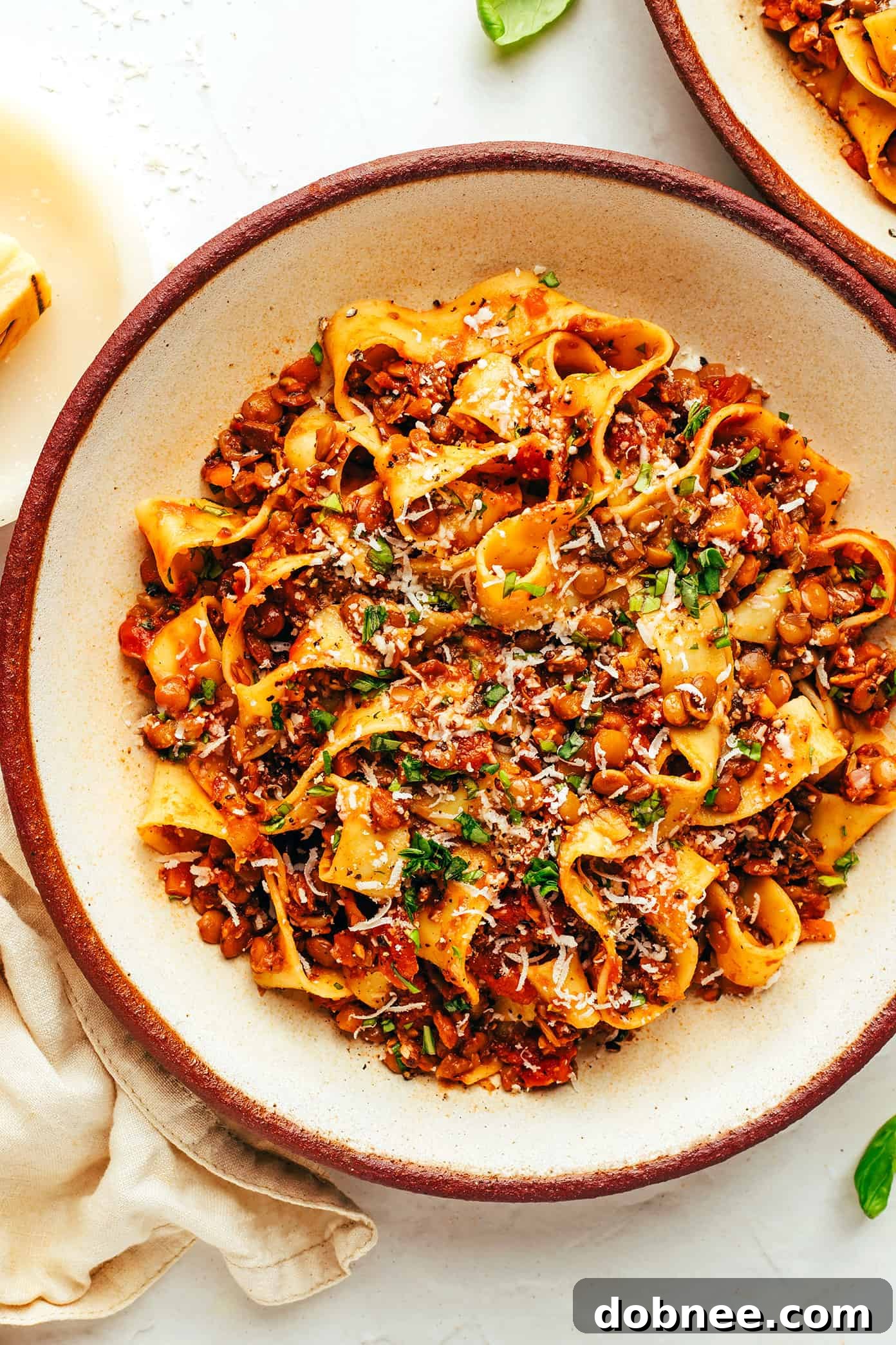Vegetarian bolognese with pasta, parmesan and basil in bowl