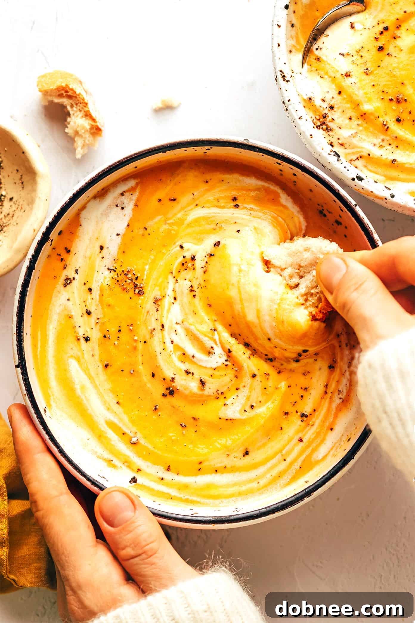 Velvety Vegetable Medley 2 A bowl of creamy roasted vegetable soup garnished with fresh herbs, ready to be enjoyed.