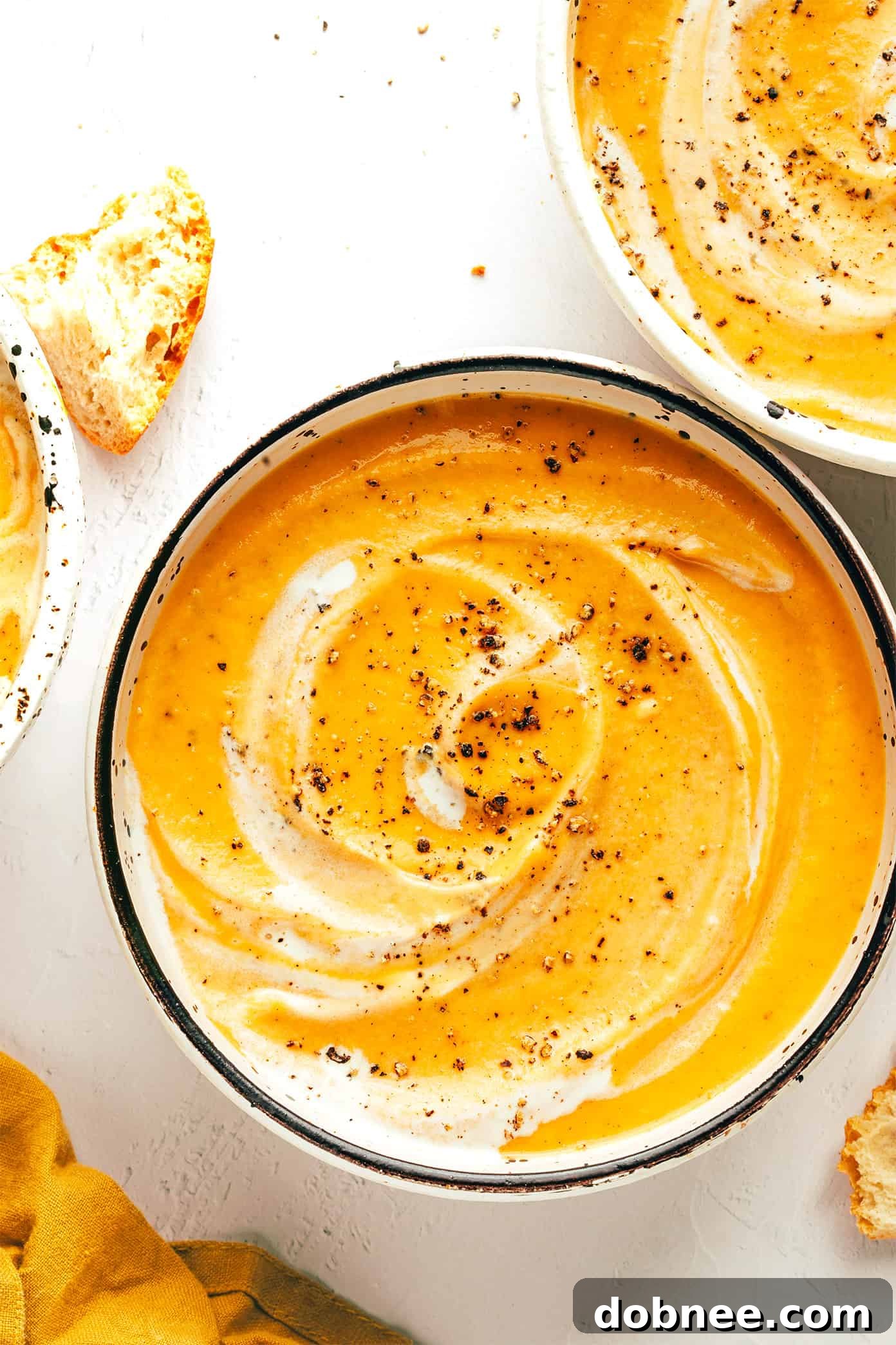 Velvety Vegetable Medley 6 A top-down view of a large pot of creamy roasted vegetable soup, ready to be served, with a ladle resting inside.