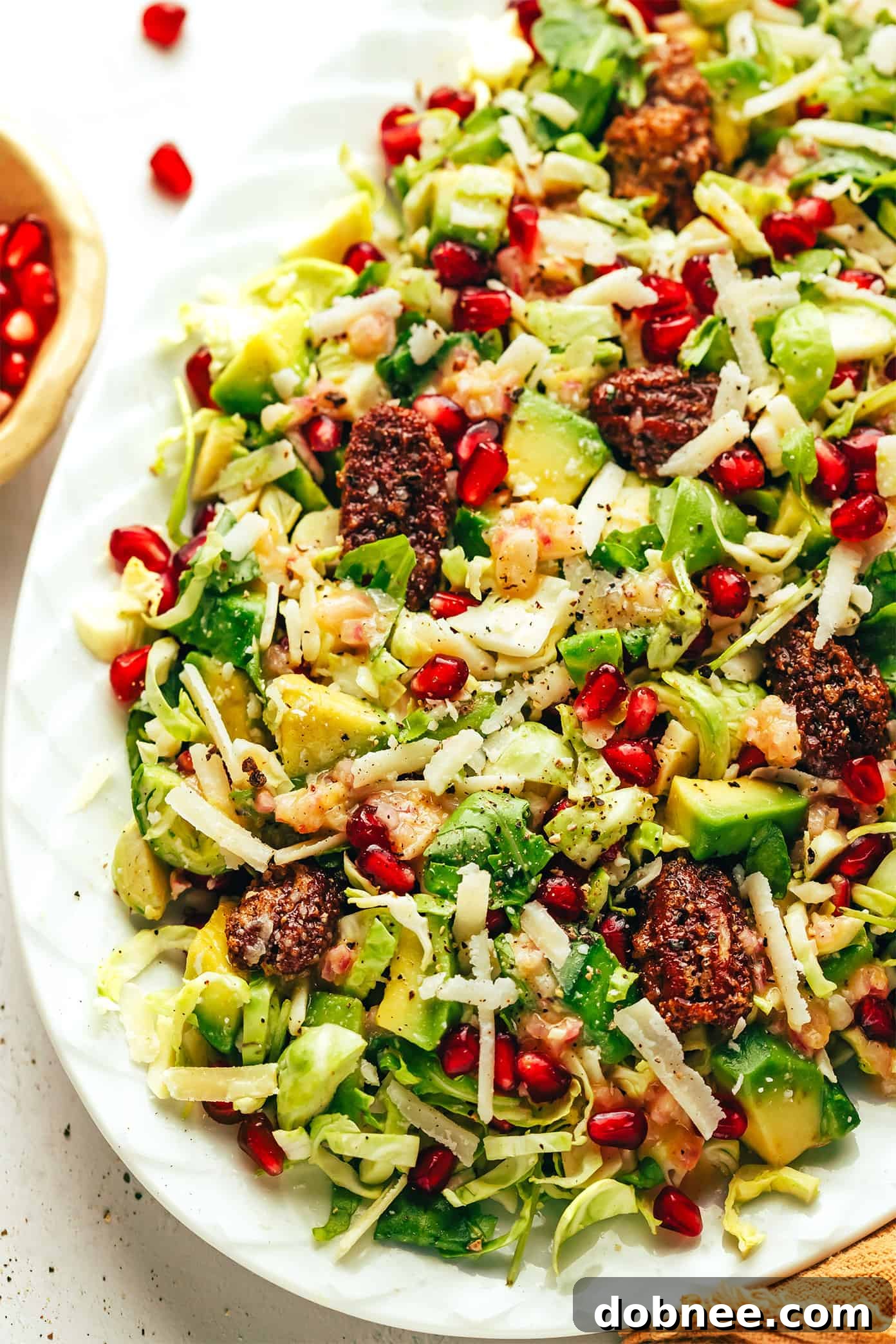 Brussels Sprouts Arugula Salad with Pomegranate and Parmesan