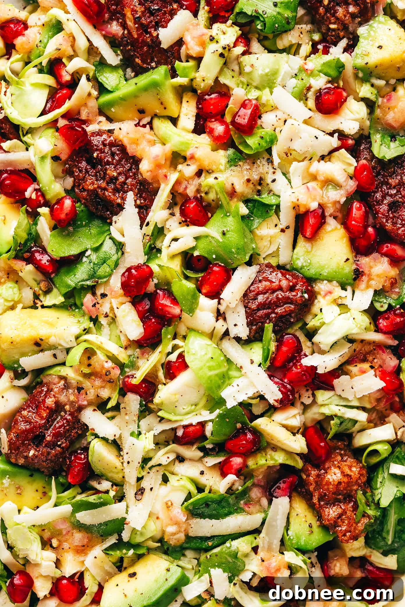 Brussels Sprouts Arugula Salad with Pomegranate and Parmesan, close up on the dressing