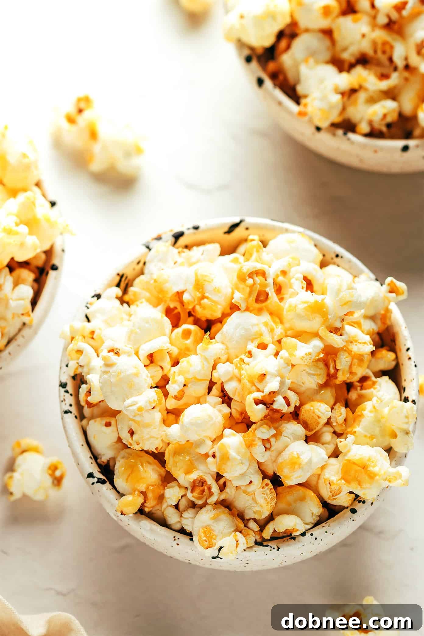 A finished bowl of kettle corn on a wooden surface.
