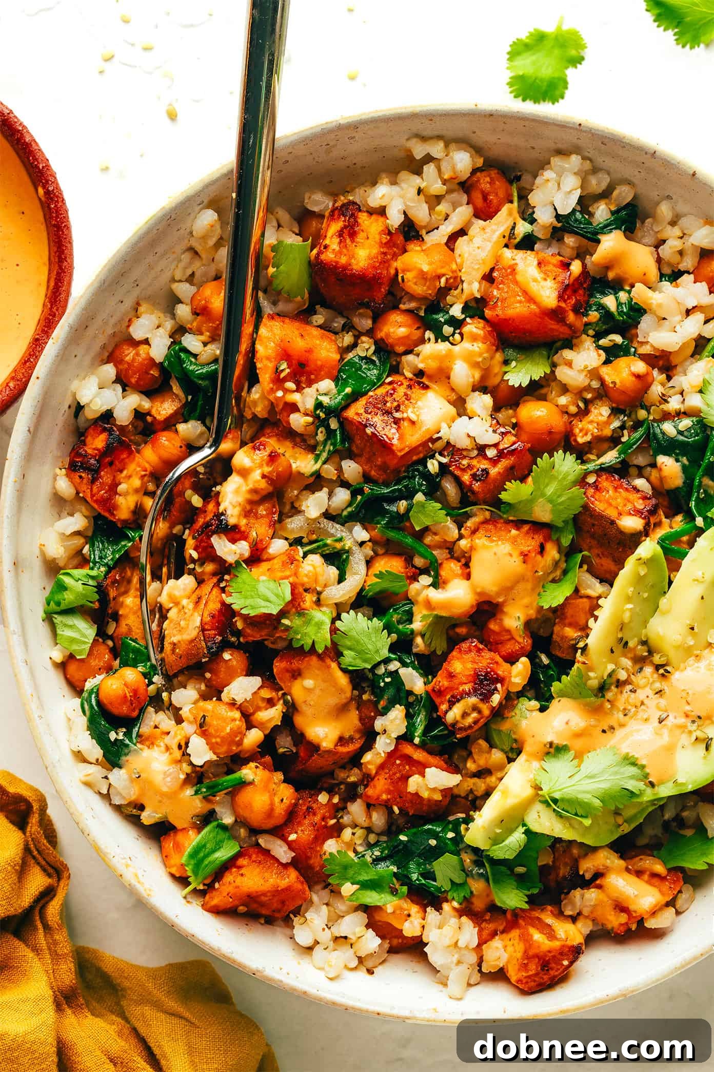 A final close-up of a serving of the sweet potato and chickpea bowl, highlighting the colorful ingredients.