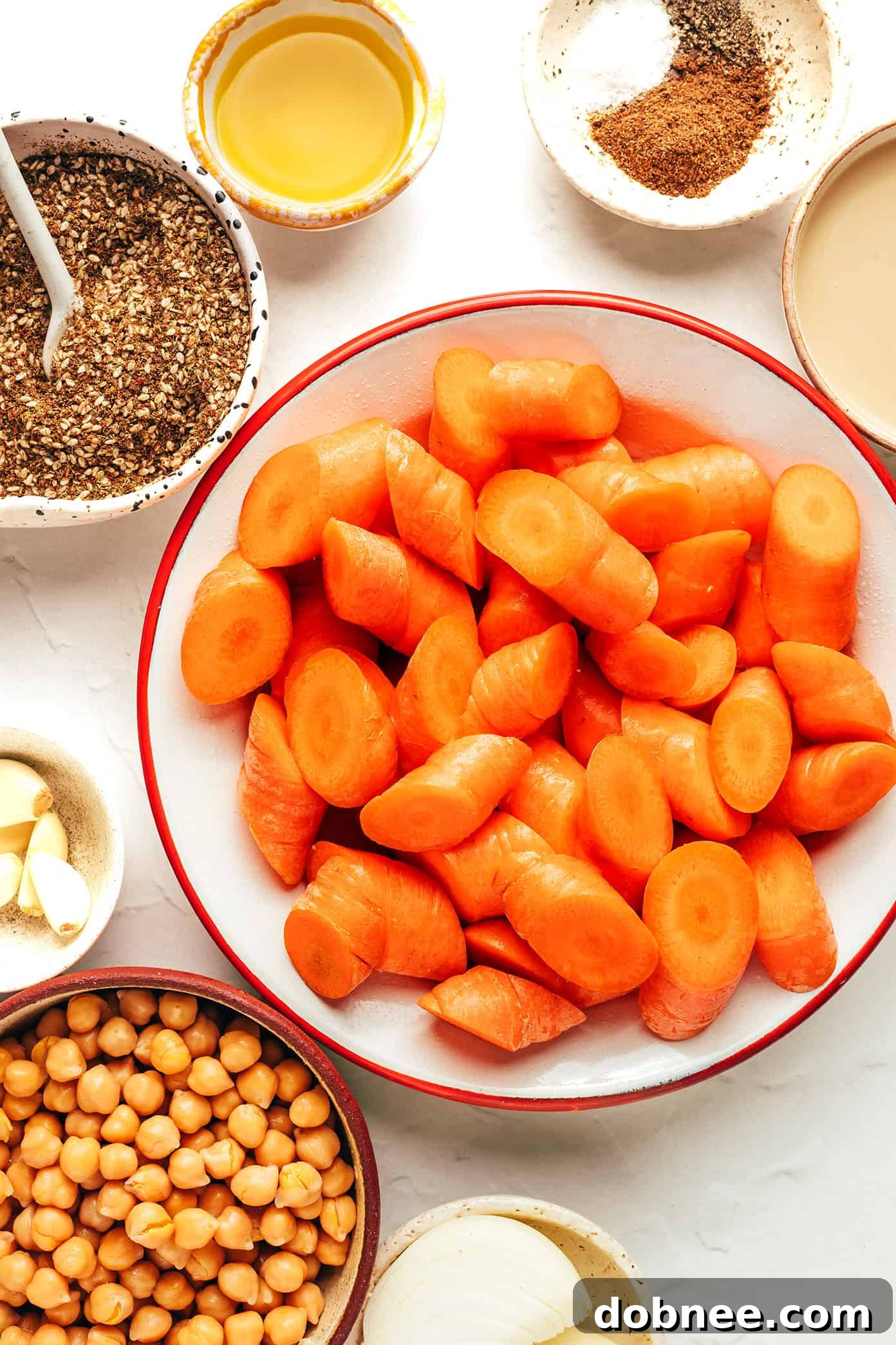 A close-up of the roasted carrot soup being poured into a bowl, showcasing its creamy texture.