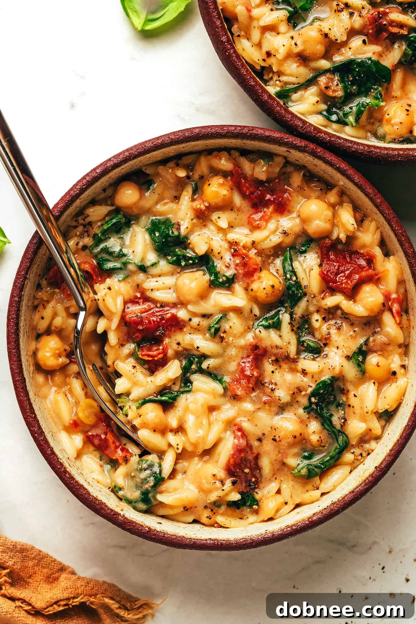 Overhead shot of the Marry Me Chickpeas and Orzo with a spoon, ready to be served