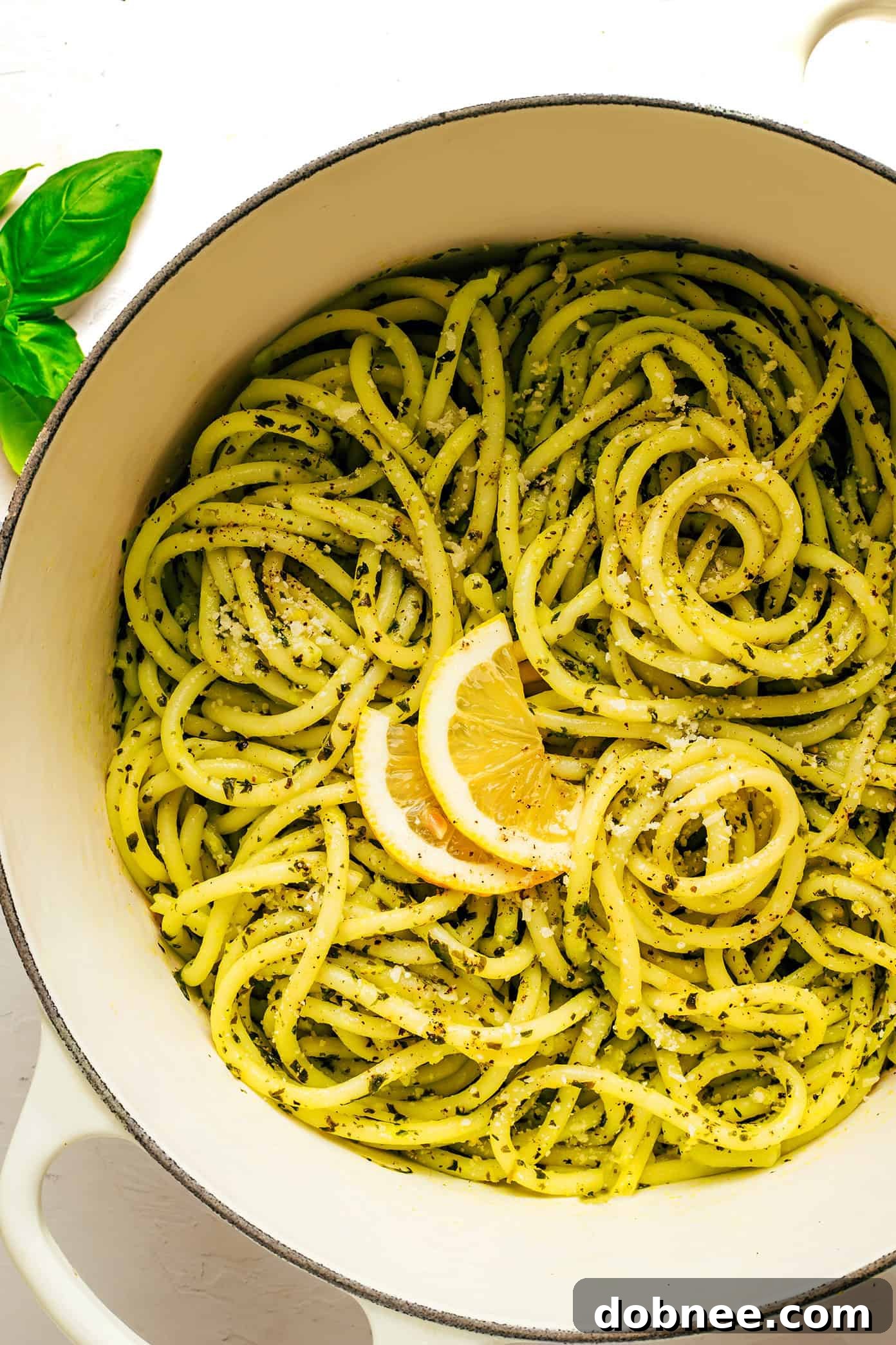A vibrant bowl of Lemon Basil Butter Pasta, garnished with fresh basil leaves and grated Parmesan cheese, ready to be served.