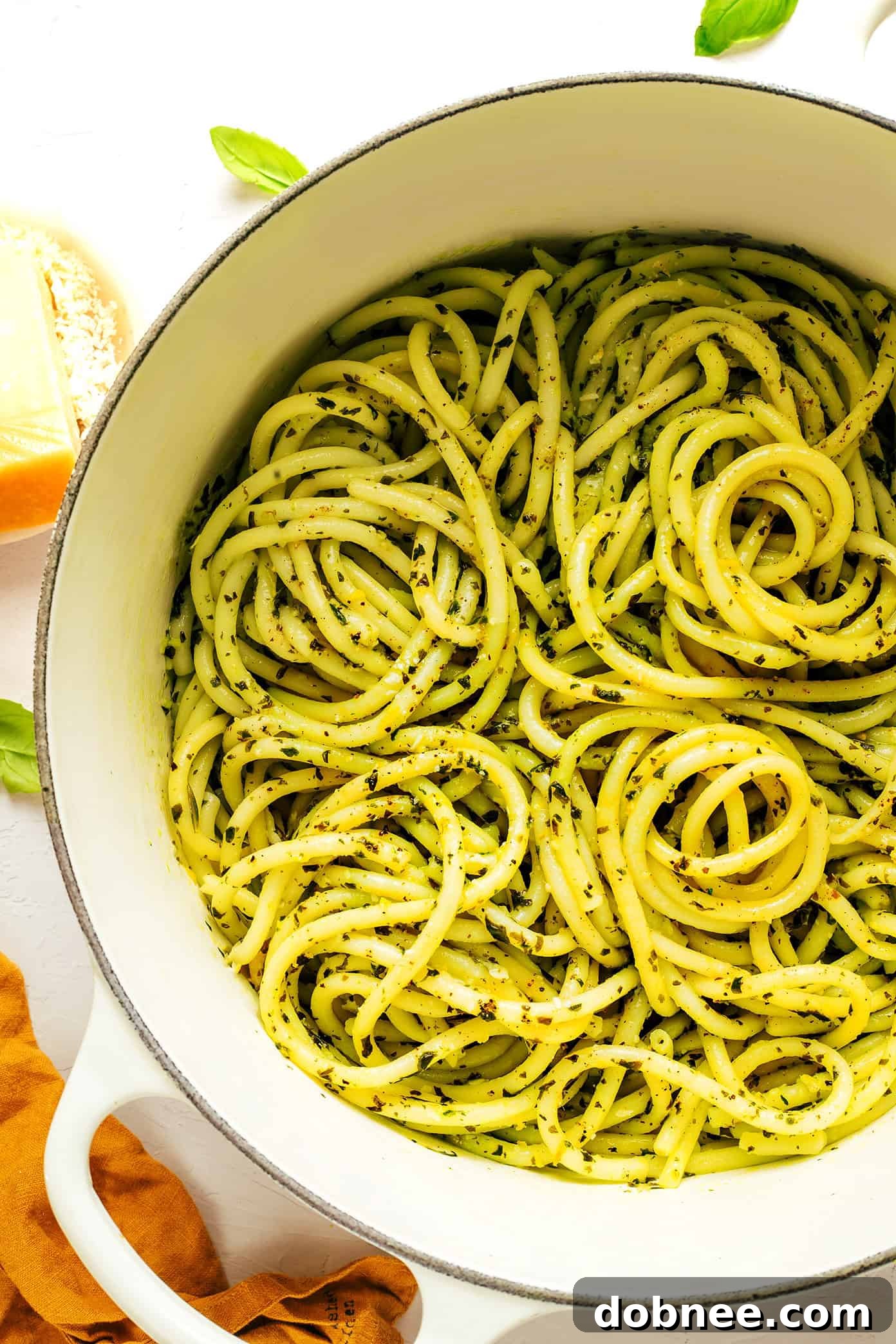 Lemon basil butter bucatini pasta served in a large cooking pot, ready to be portioned into bowls.