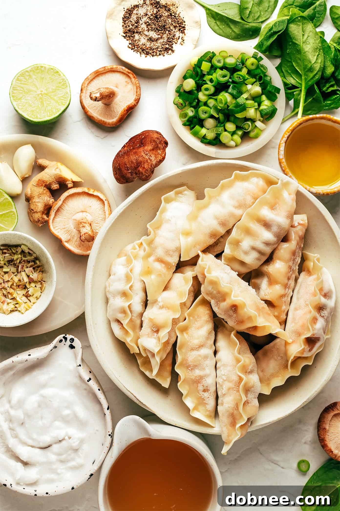 Ginger coconut potsticker soup ingredients laid out on a wooden surface