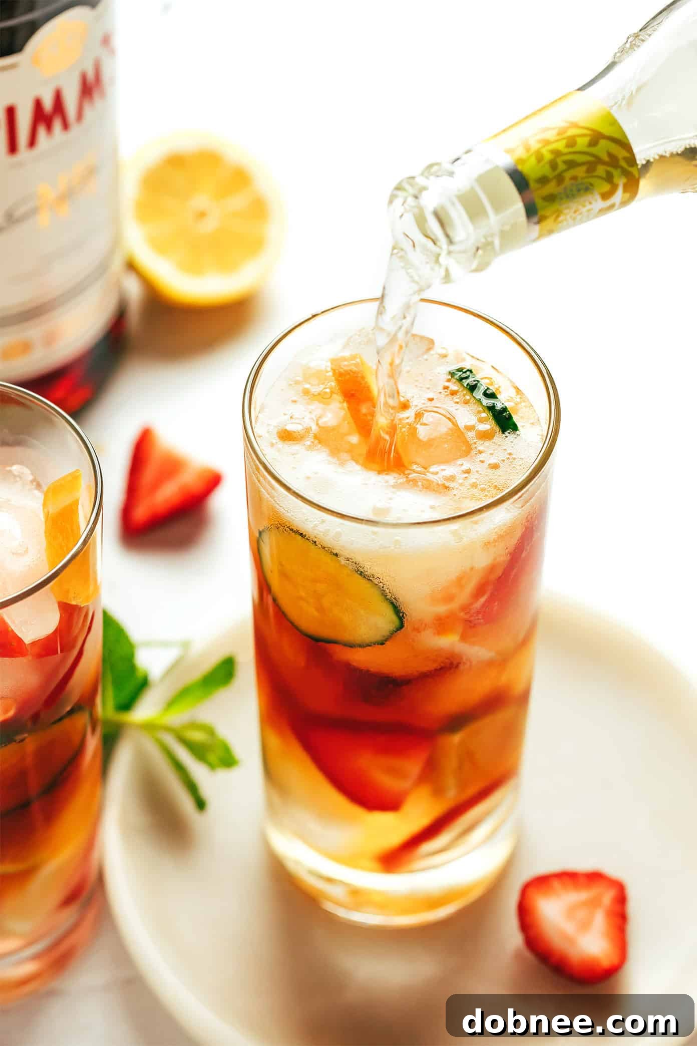 A beautifully composed Pimm's Cup cocktail with various fruits and a sprig of mint, viewed from above, inviting a refreshing sip.