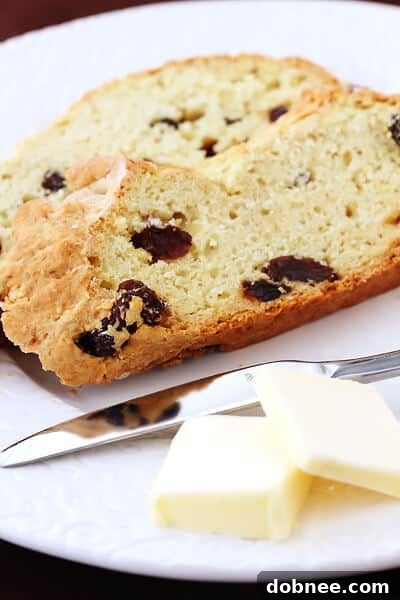 Close-up of a rustic, golden-brown Irish Soda Bread loaf, freshly baked.