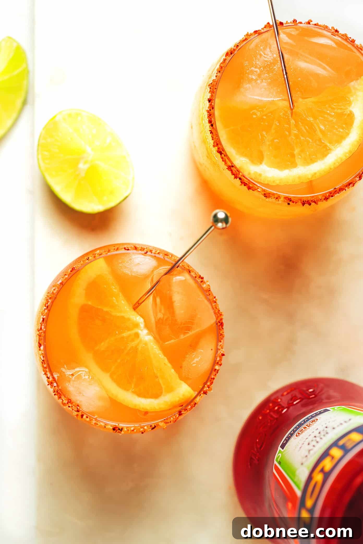 Another view of a vibrant Aperol Margarita, garnished with an orange slice, ready to be enjoyed.