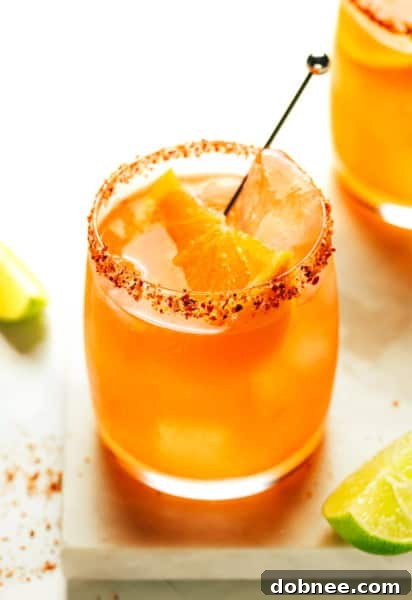 A vibrant Aperol Margarita with an orange slice garnish.