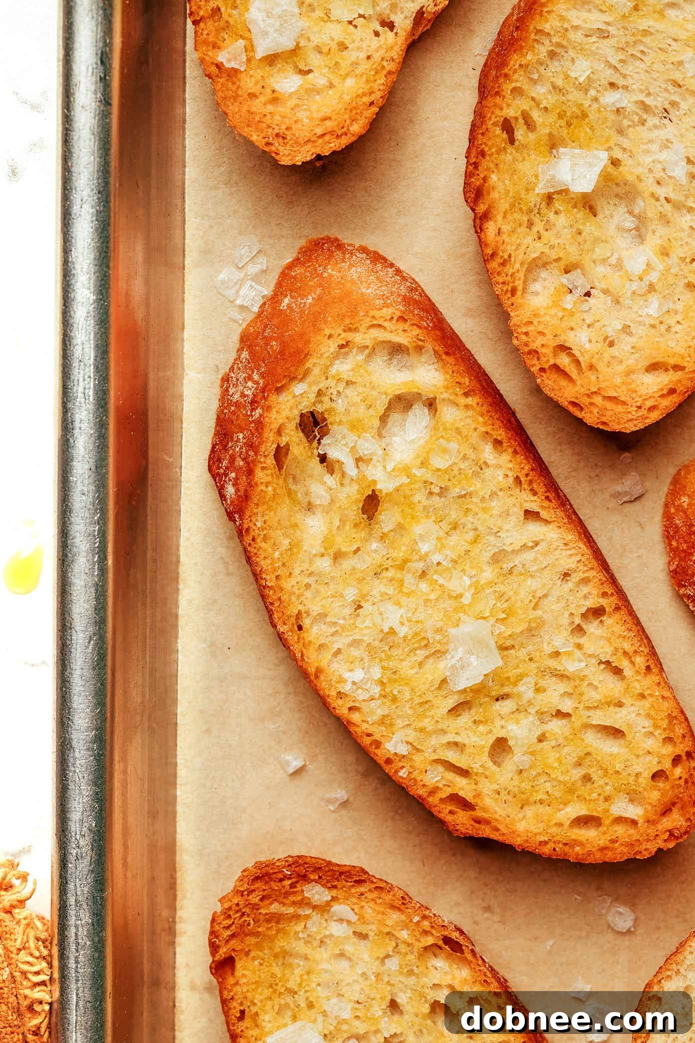 Various crostini toppings, including goat cheese and honey, fig jam and prosciutto, and mushrooms, artfully arranged.