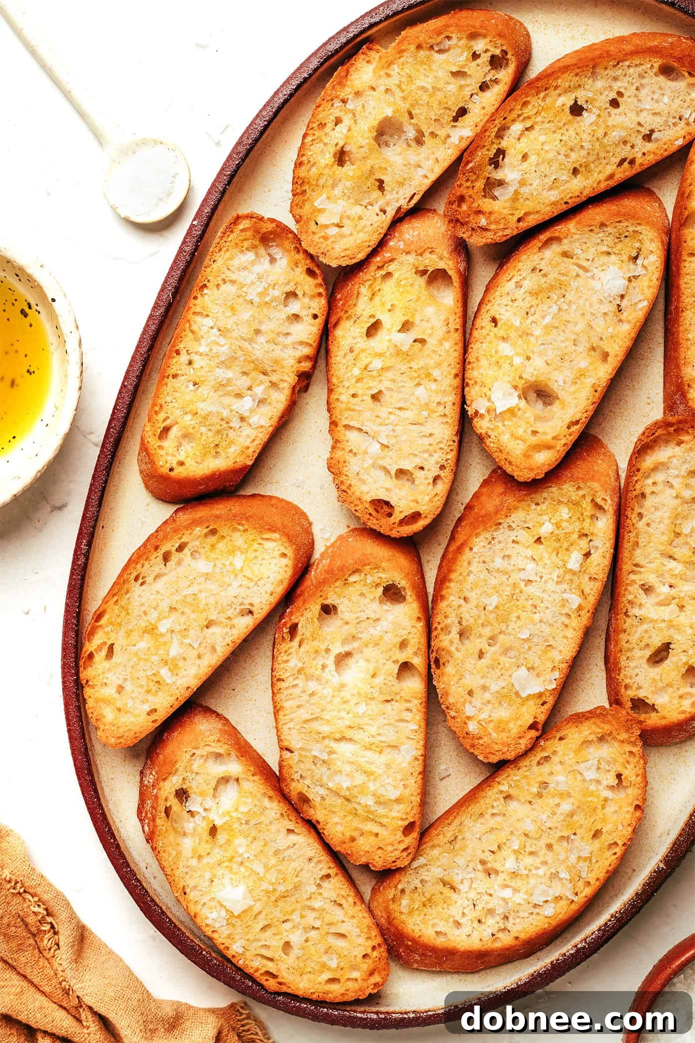 Assortment of crostini with various toppings, including avocado and egg, olive tapenade, and caramelized onion and Gruyere.
