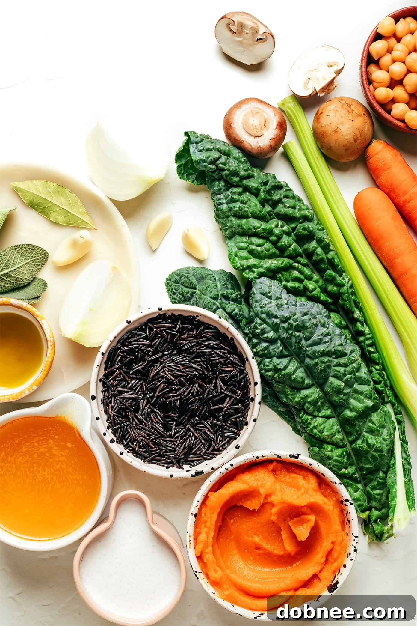 Close-up of creamy pumpkin wild rice soup with kale and chickpeas, showcasing its rich texture.