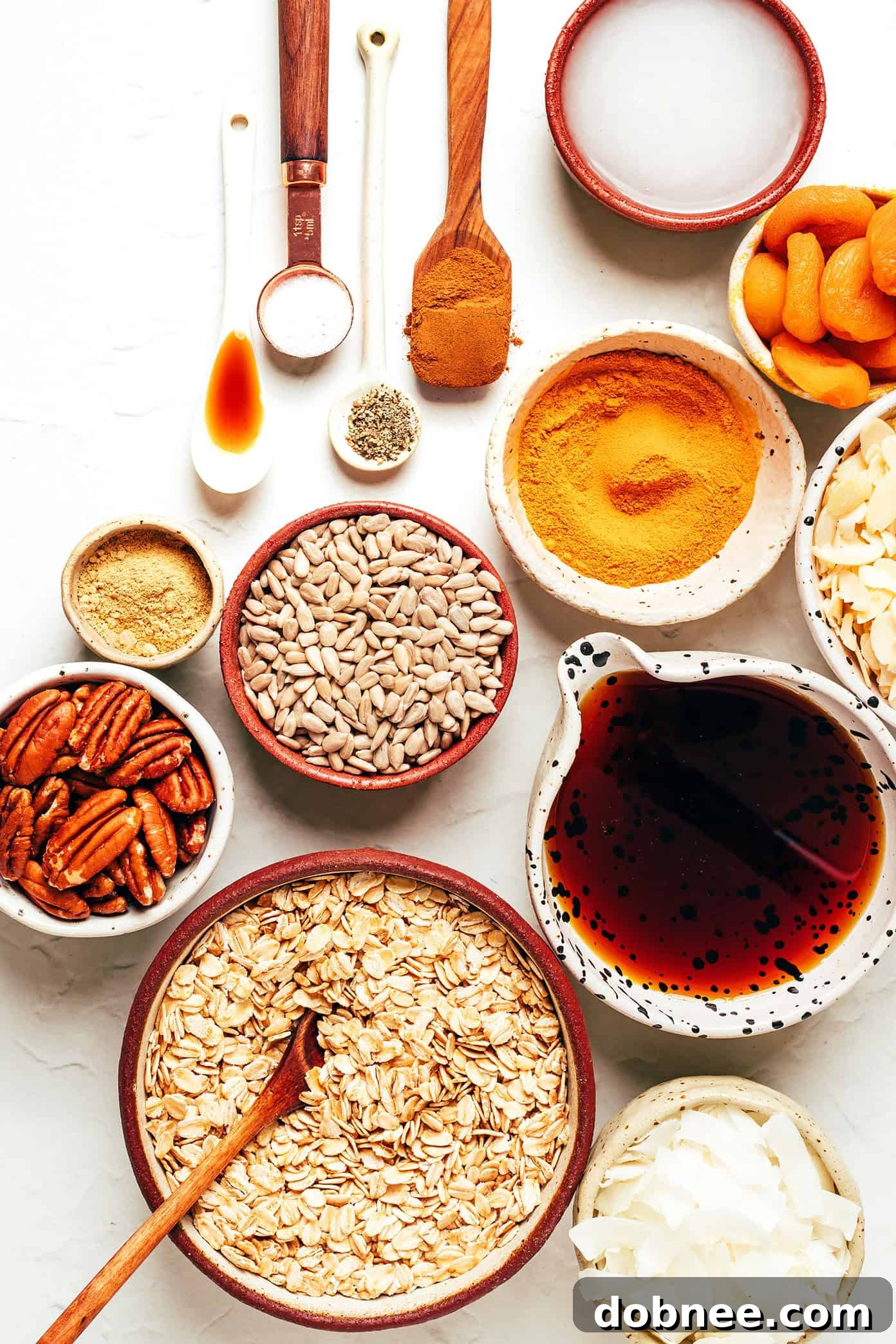 A close-up shot of Golden Granola in a pristine white bowl, highlighting its crunchy clusters and the golden hue of the spices.
