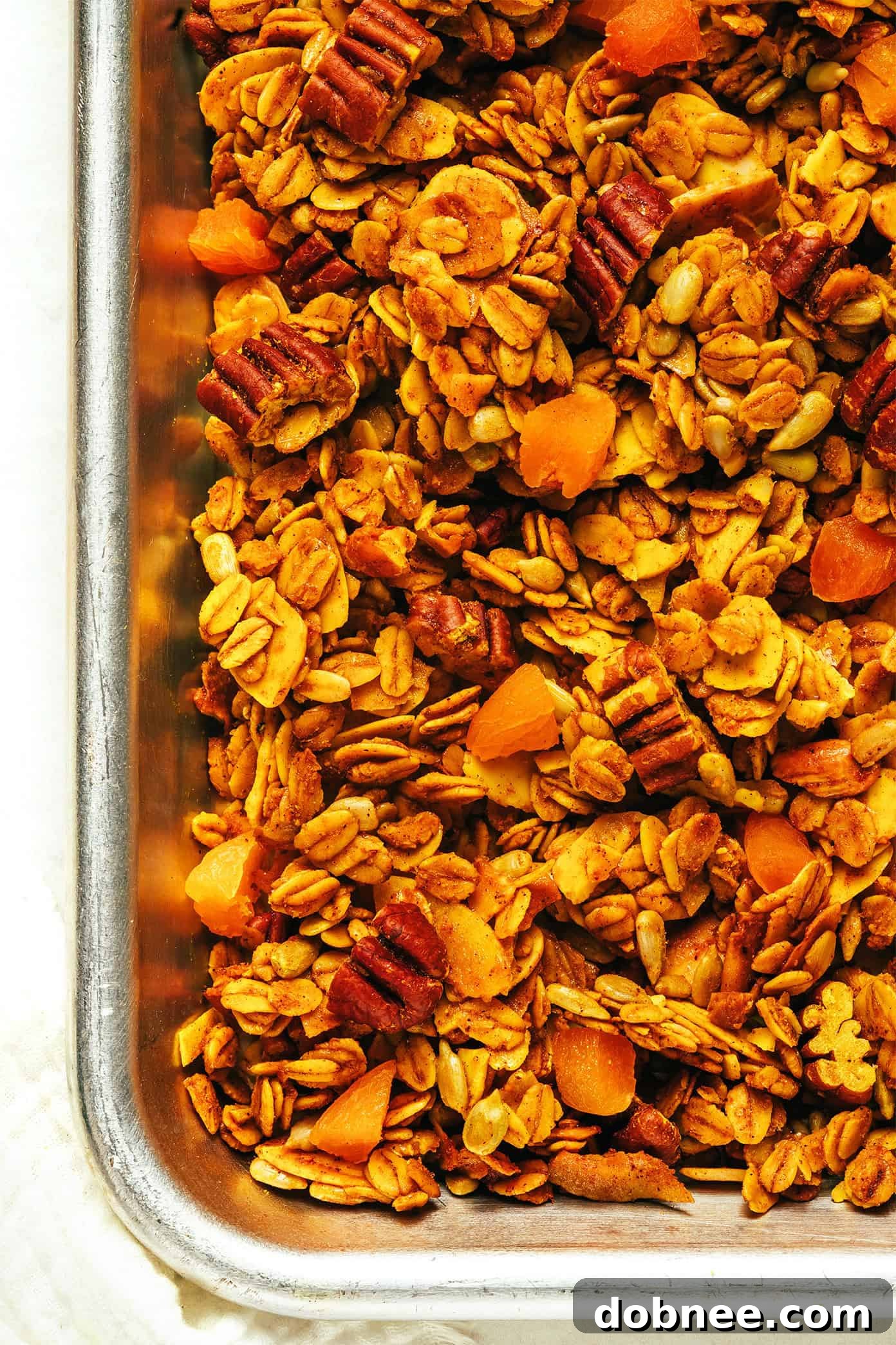 A beautiful wide shot of a glass jar filled with golden granola, placed on a rustic wooden table, ready for healthy snacking.