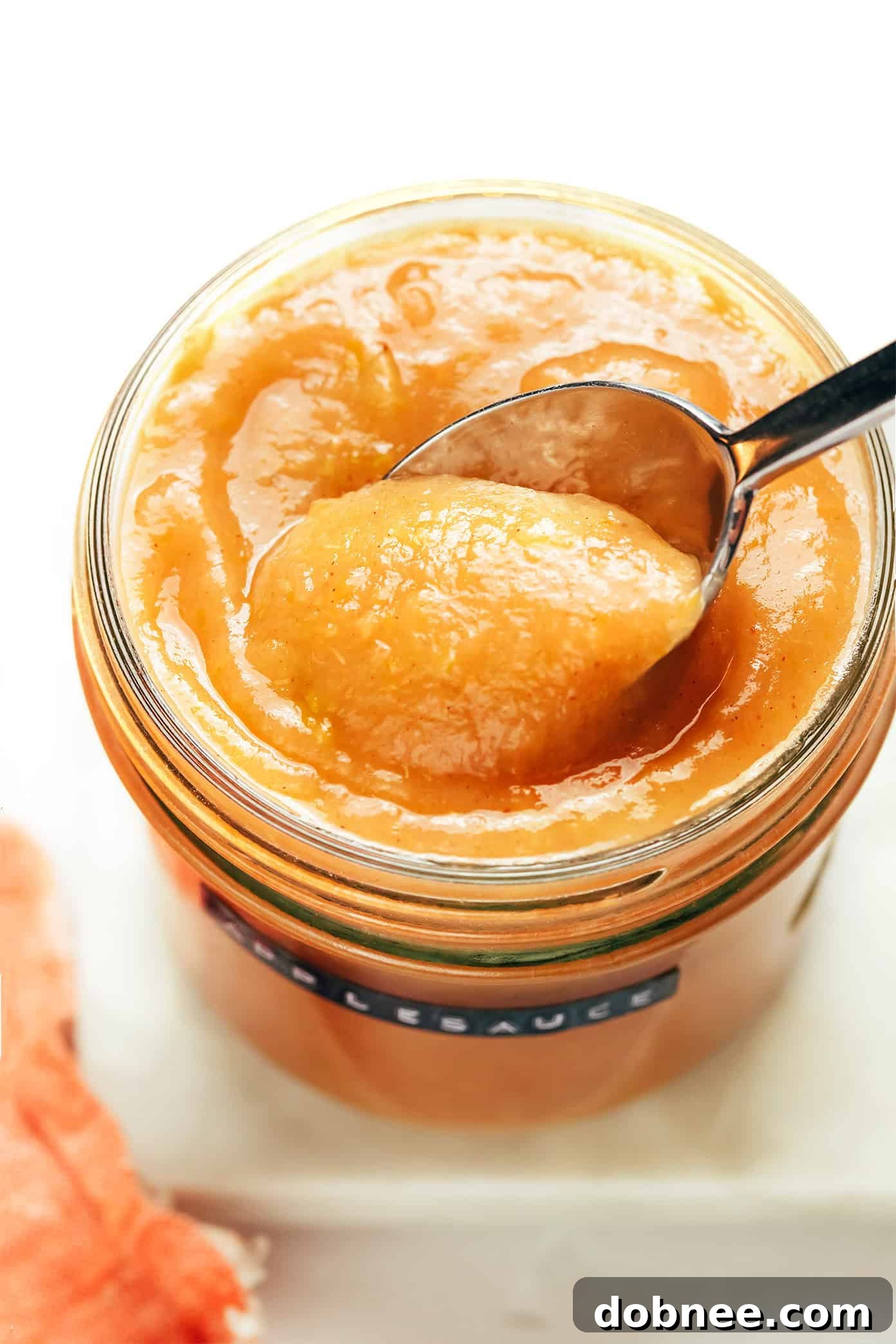 An aerial shot of a full Instant Pot applesauce bowl with a spoon.