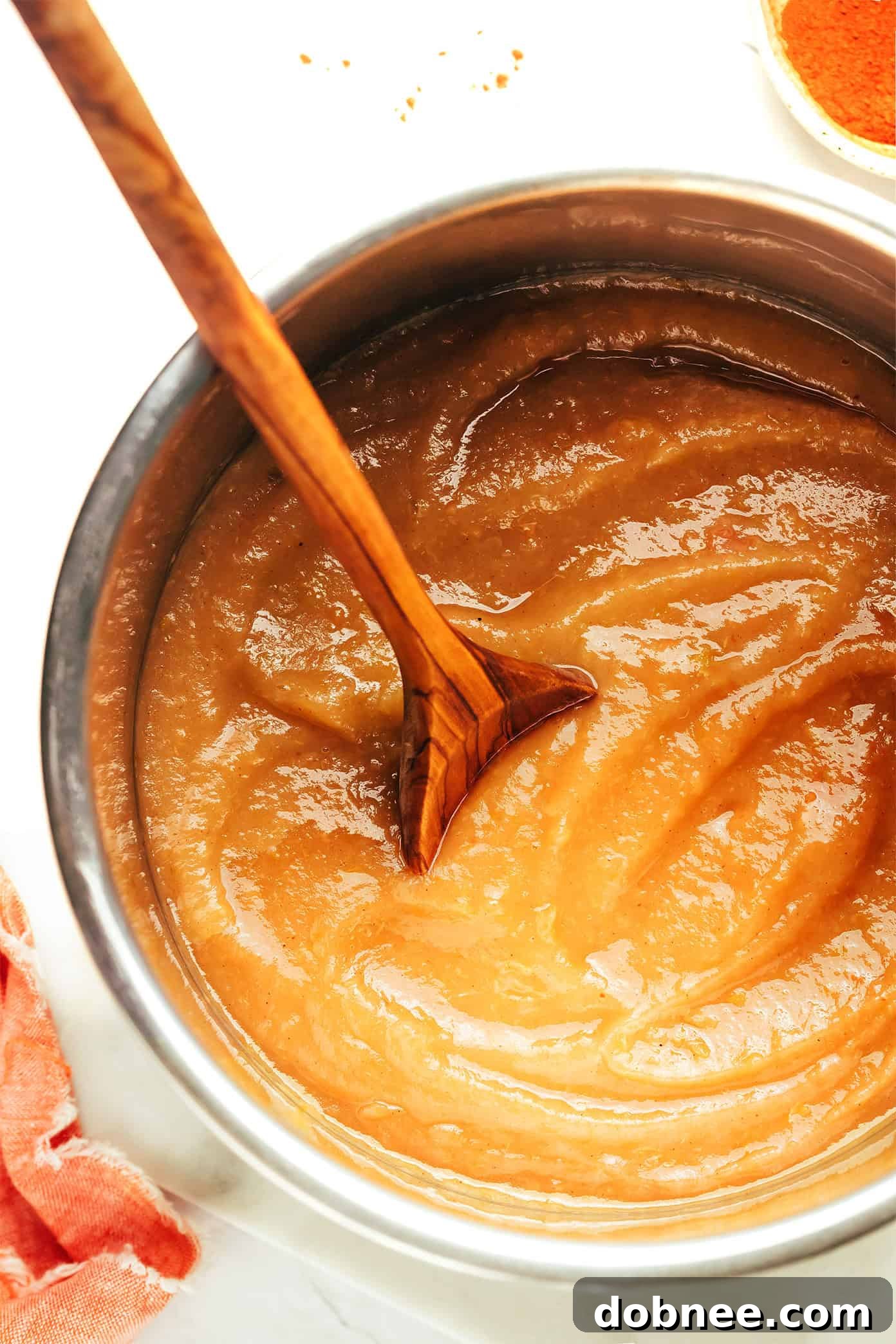 A spoon scooping up homemade Instant Pot applesauce.