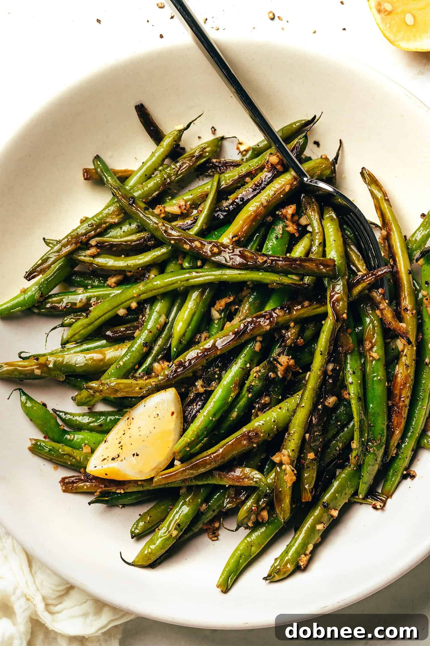 Various side dishes including garlic green beans on a rustic table