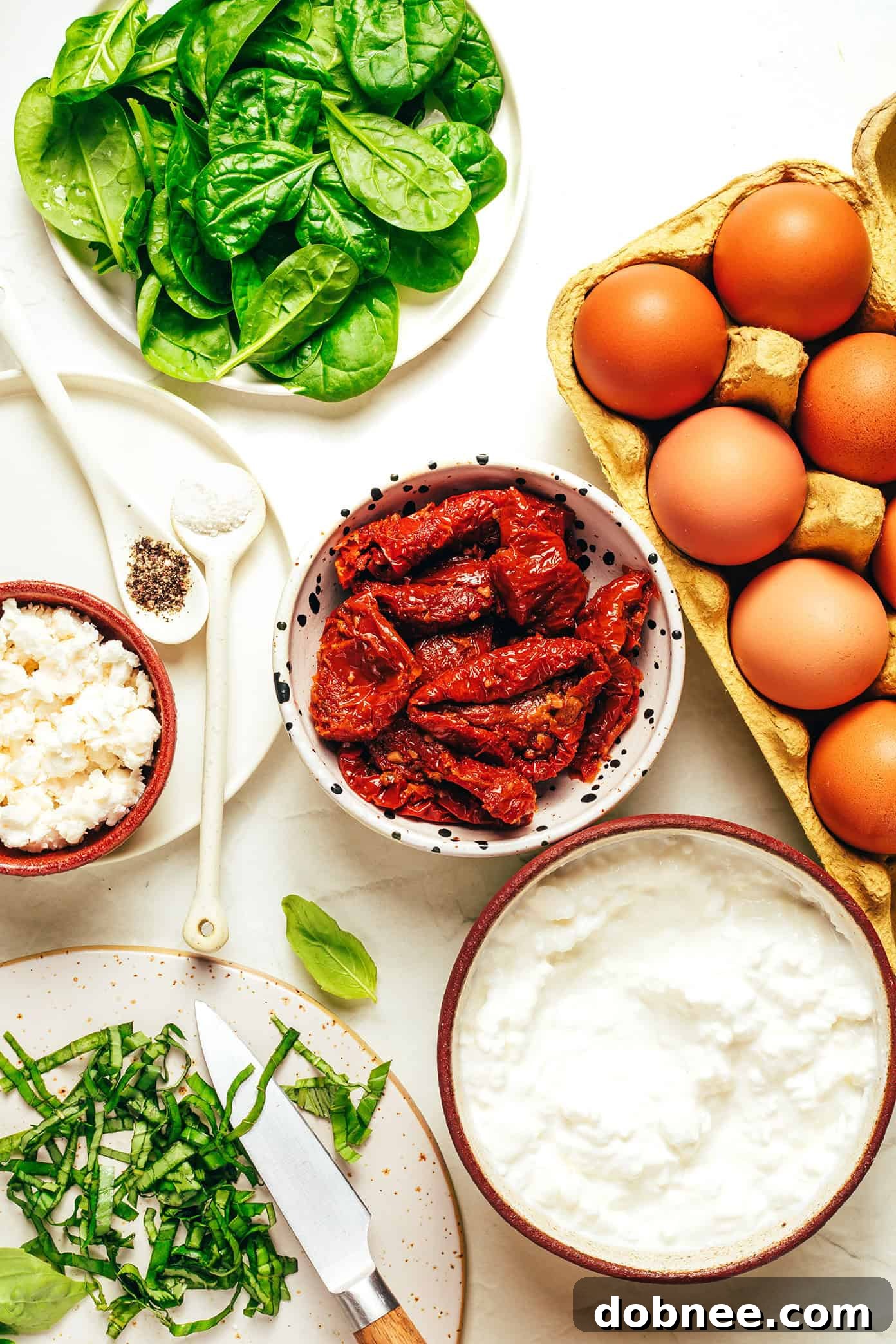 Ingredients for making high-protein egg bites laid out on a counter.
