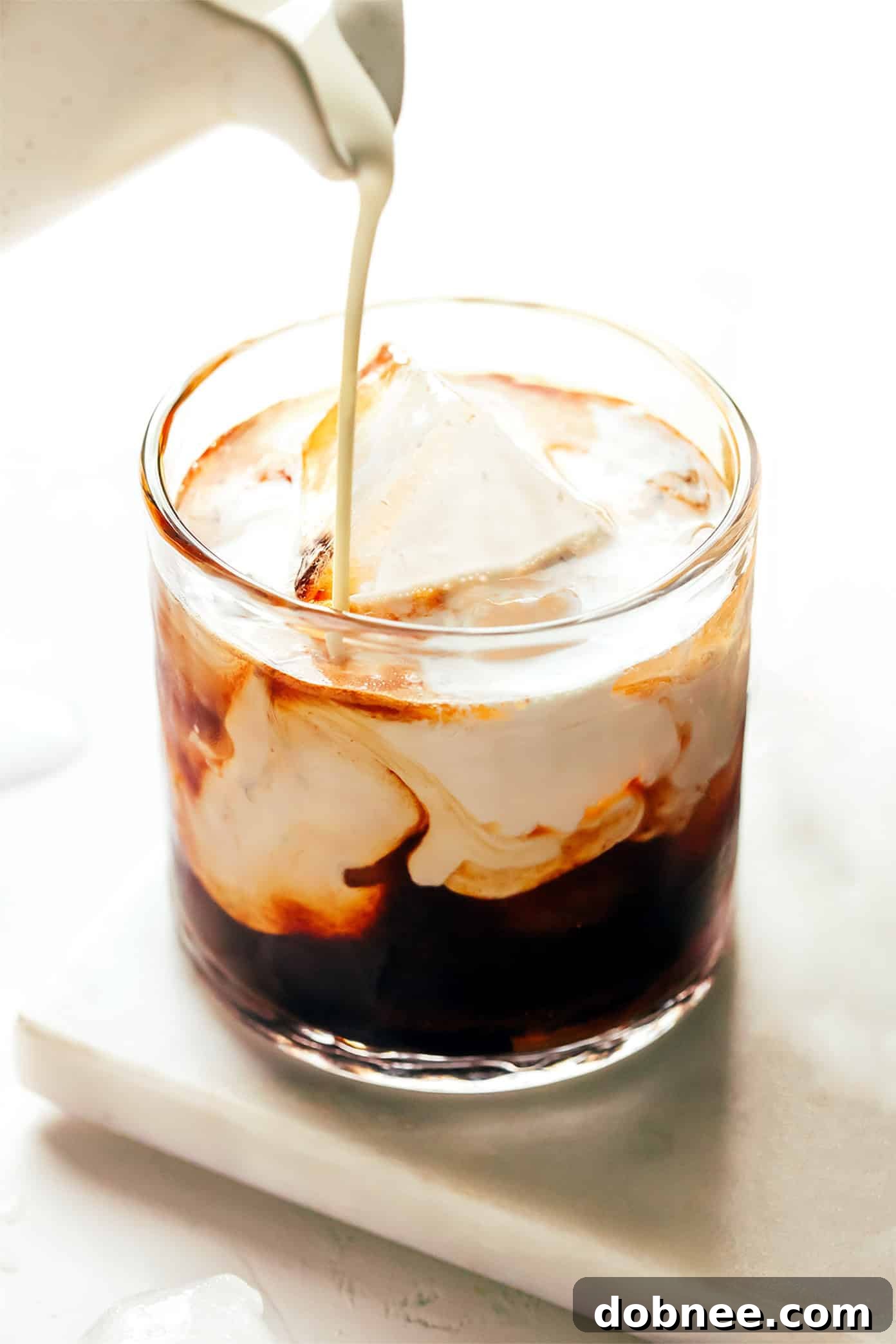 Close-up of a White Russian cocktail being stirred