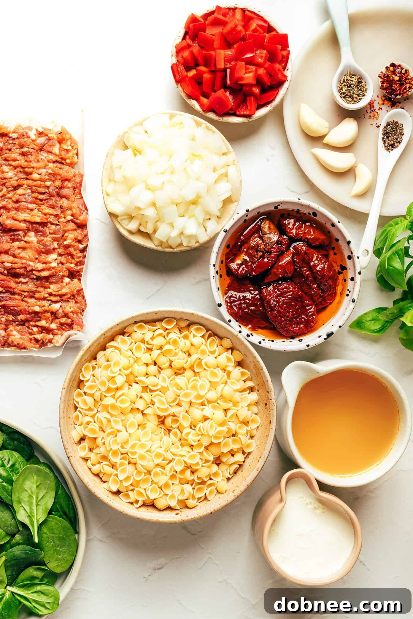 Close-up shot of creamy Marry Me Italian Sausage Soup with mini pasta shells, sun-dried tomatoes, and spinach.