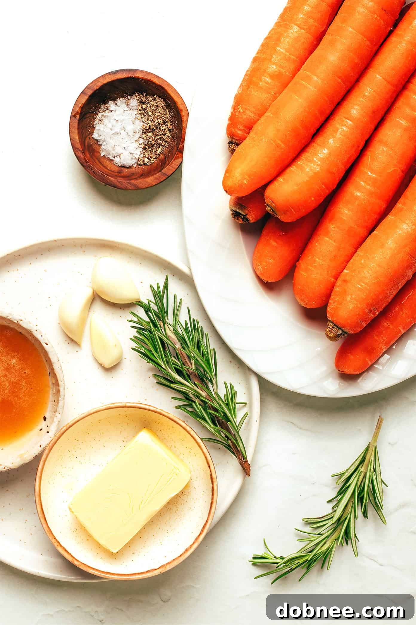 Close-up of golden-brown roasted carrots, showing the caramelized edges and the glistening honey butter sauce.