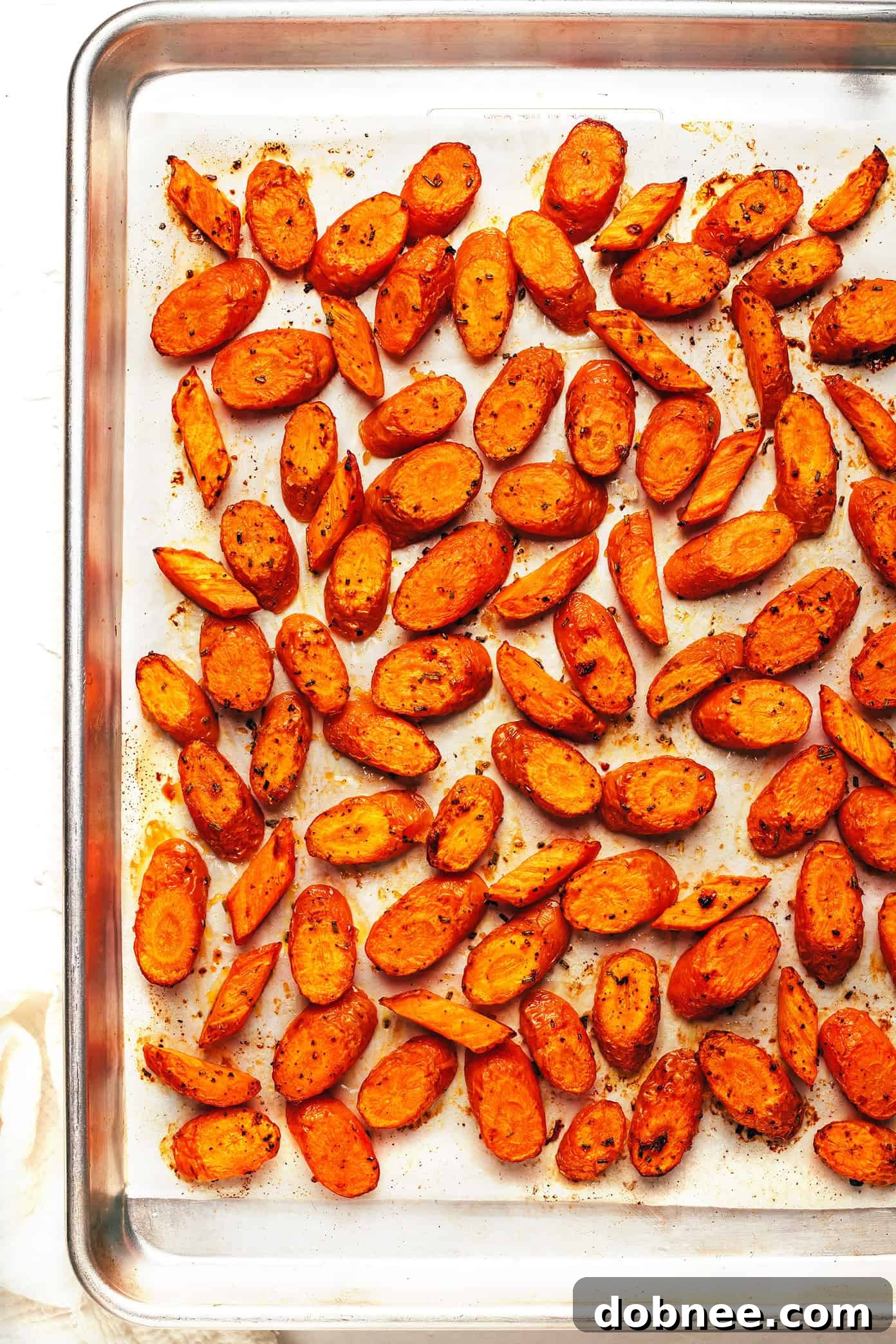 A baking sheet filled with perfectly roasted carrots, ready to be served, highlighting their golden color and glistening glaze.