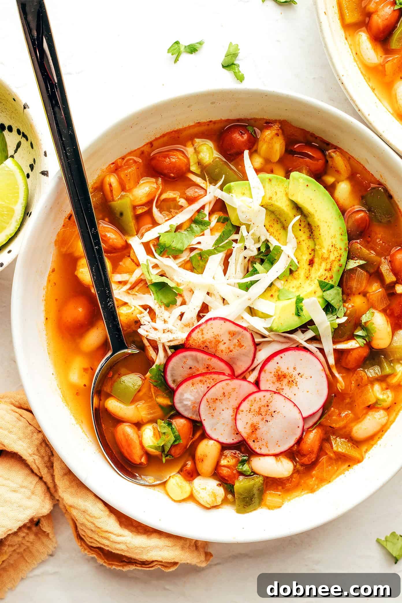 Plant-Powered Pozole 8 A top-down view of a single bowl of vegetarian pozole, richly garnished and ready to be enjoyed.