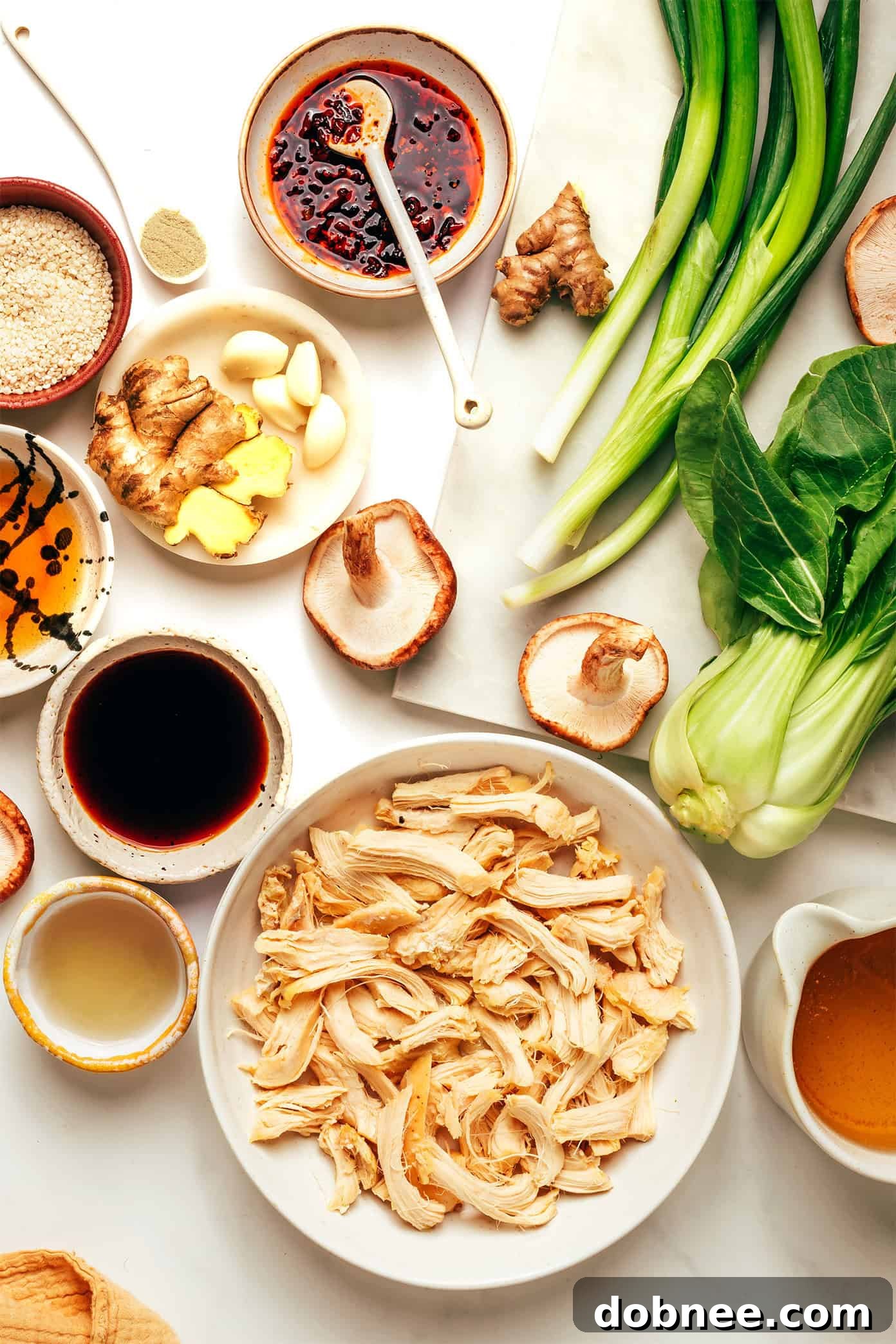 Close-up of ginger scallion chicken soup with shiitake mushrooms and bok choy.